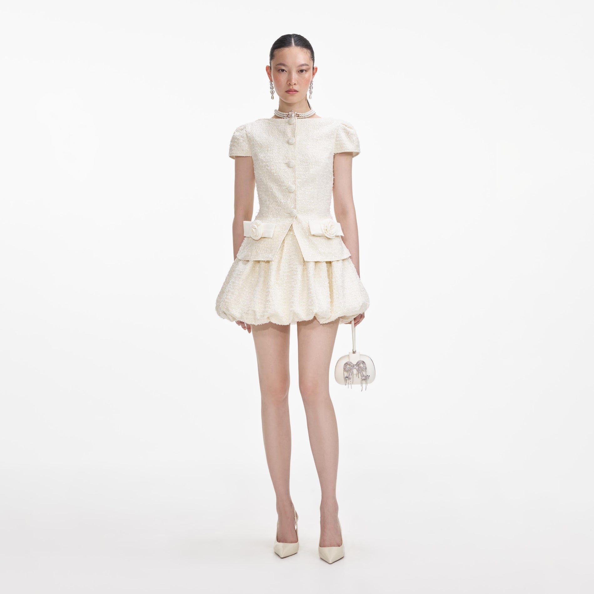 Front view of a woman wearing the Cream Boucle Bow Detail Mini Dress