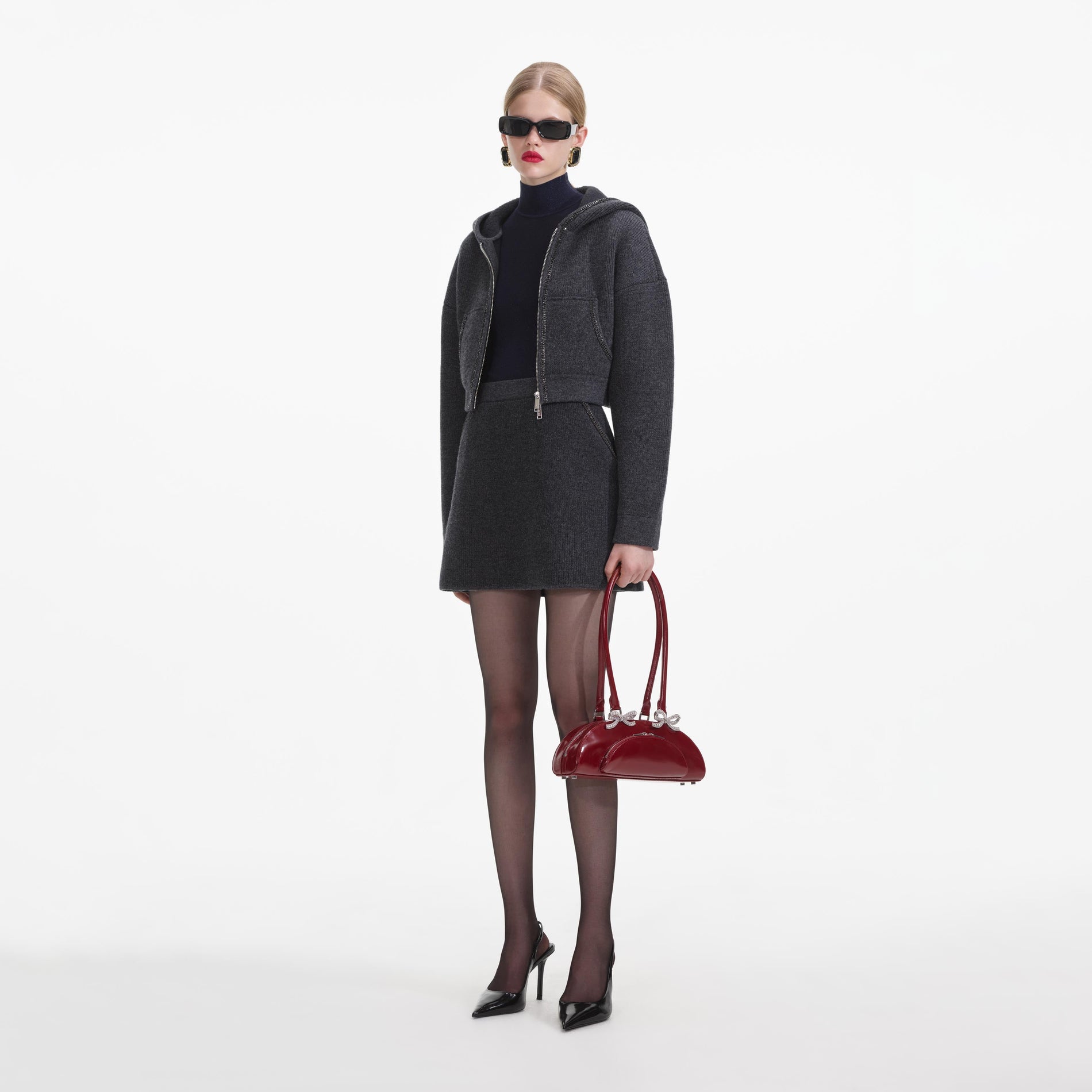 Side view of a woman wearing the Grey Knit Mini Skirt