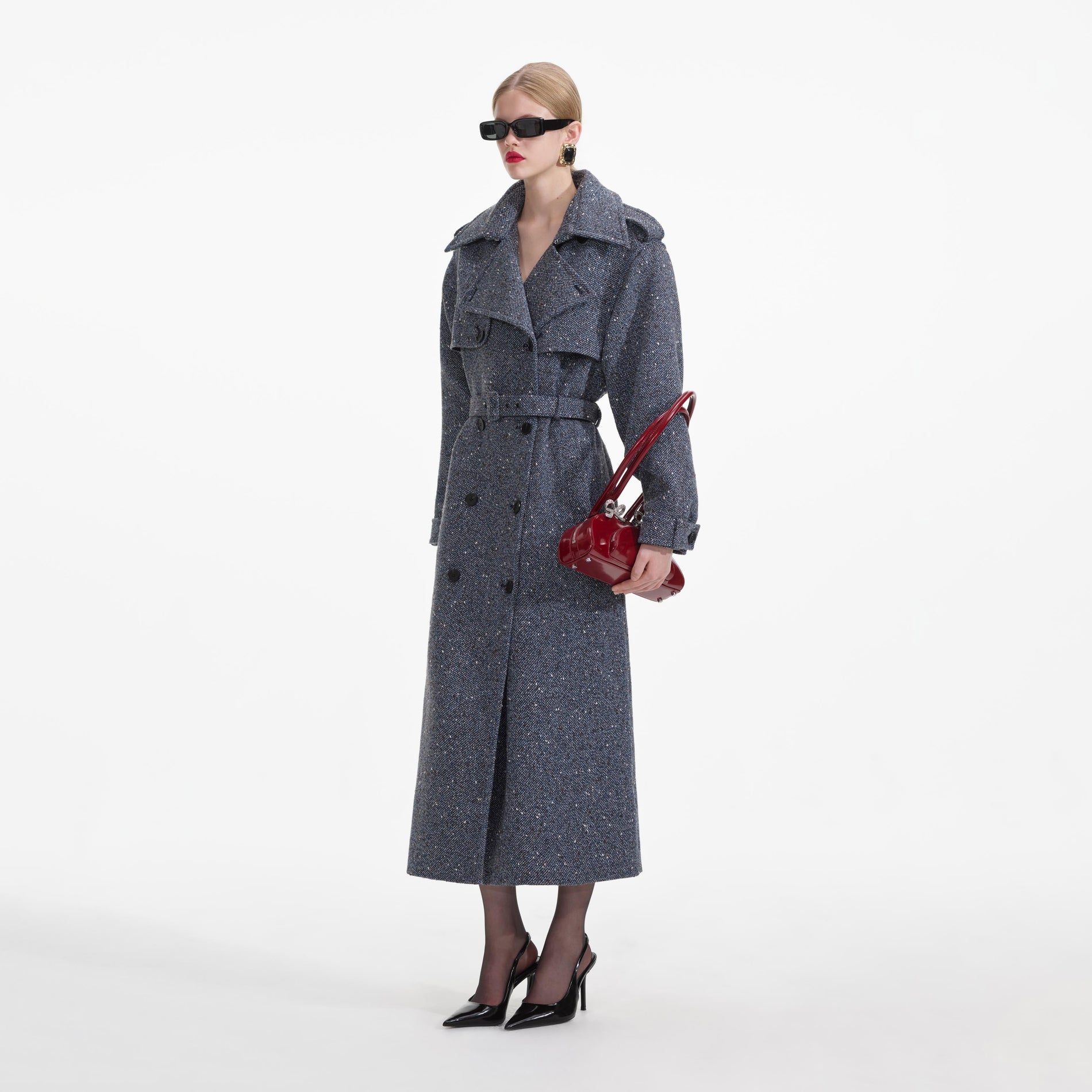 Side view of a woman wearing the Blue Boucle Trench Coat