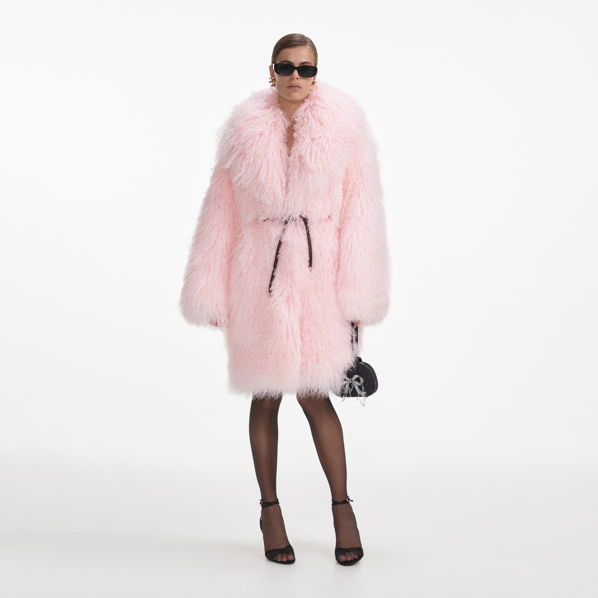 Front view of a woman wearing the Pink Shearling Coat