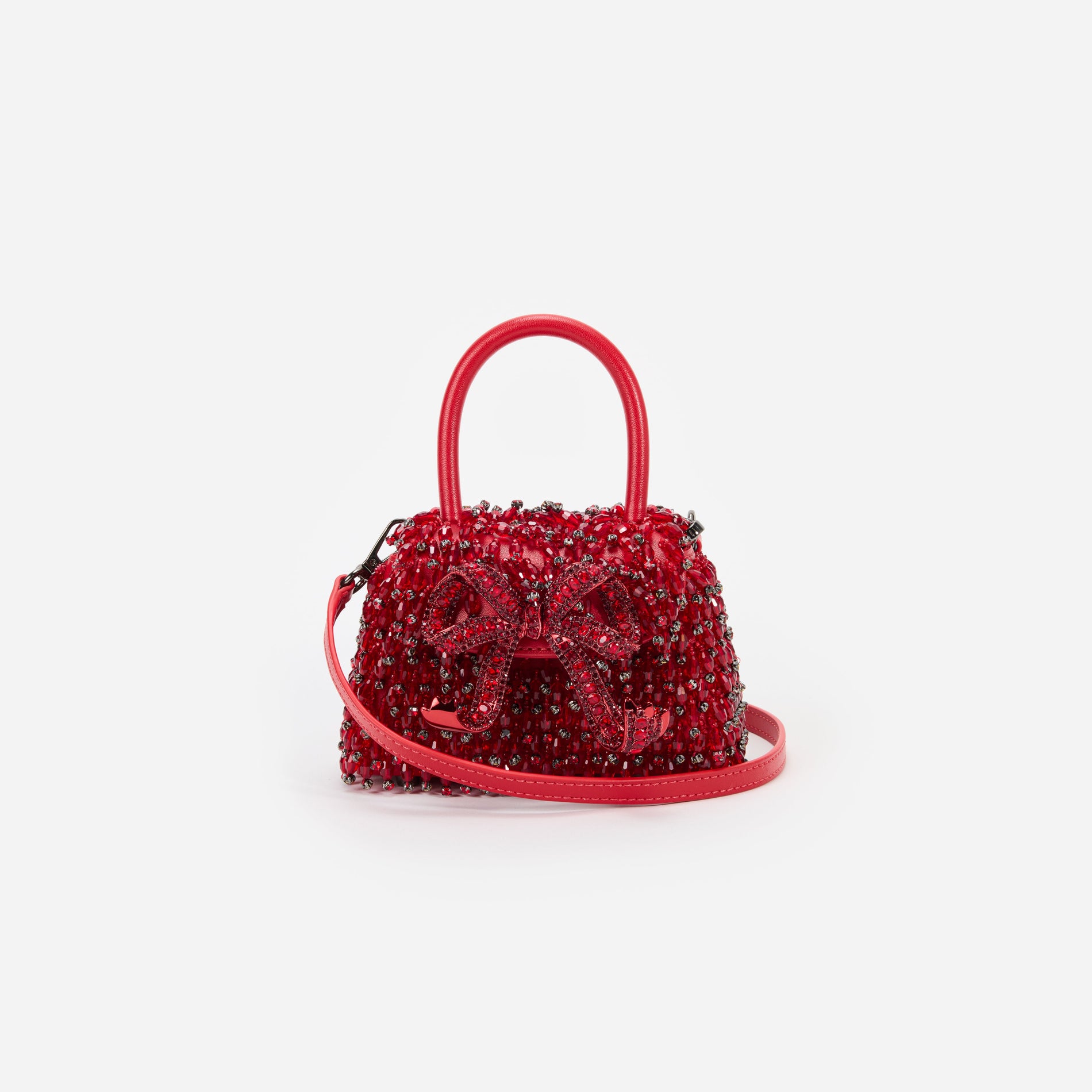 A close up of a woman wearing the Red Embellished Micro Bow Bag