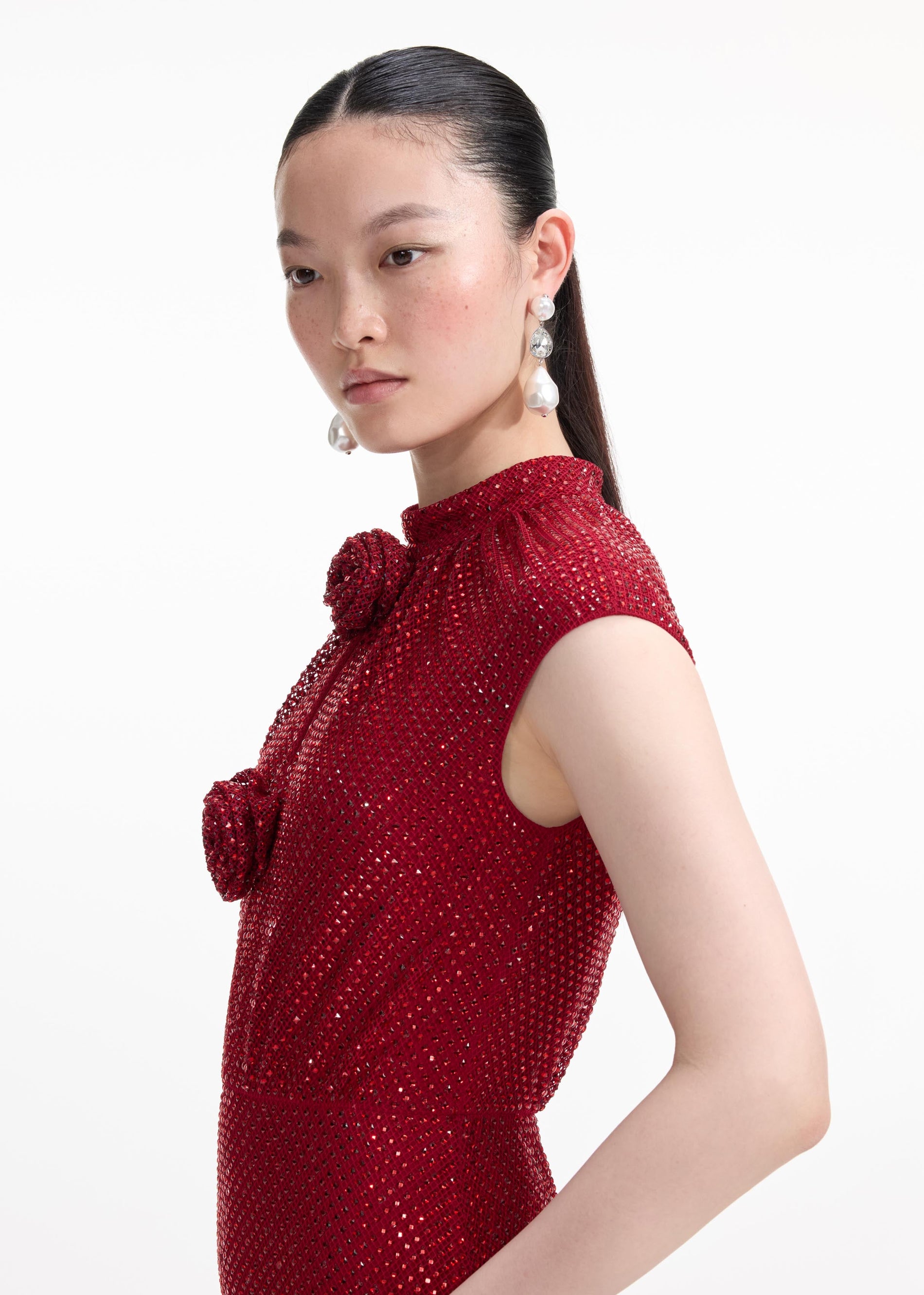 A close up of a woman wearing the Pearl Crystal Droplet Earrings