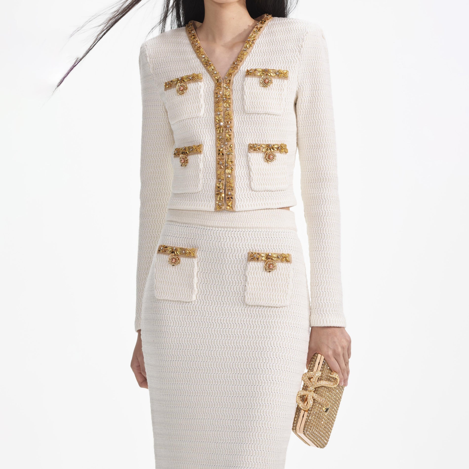 A close up of a woman wearing the Cream Lurex Knit Midi Skirt