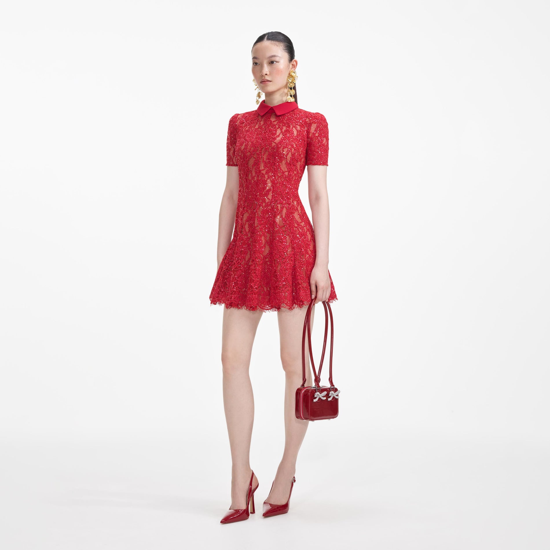 Side view of a woman wearing the Red Sequin Lace Mini Dress