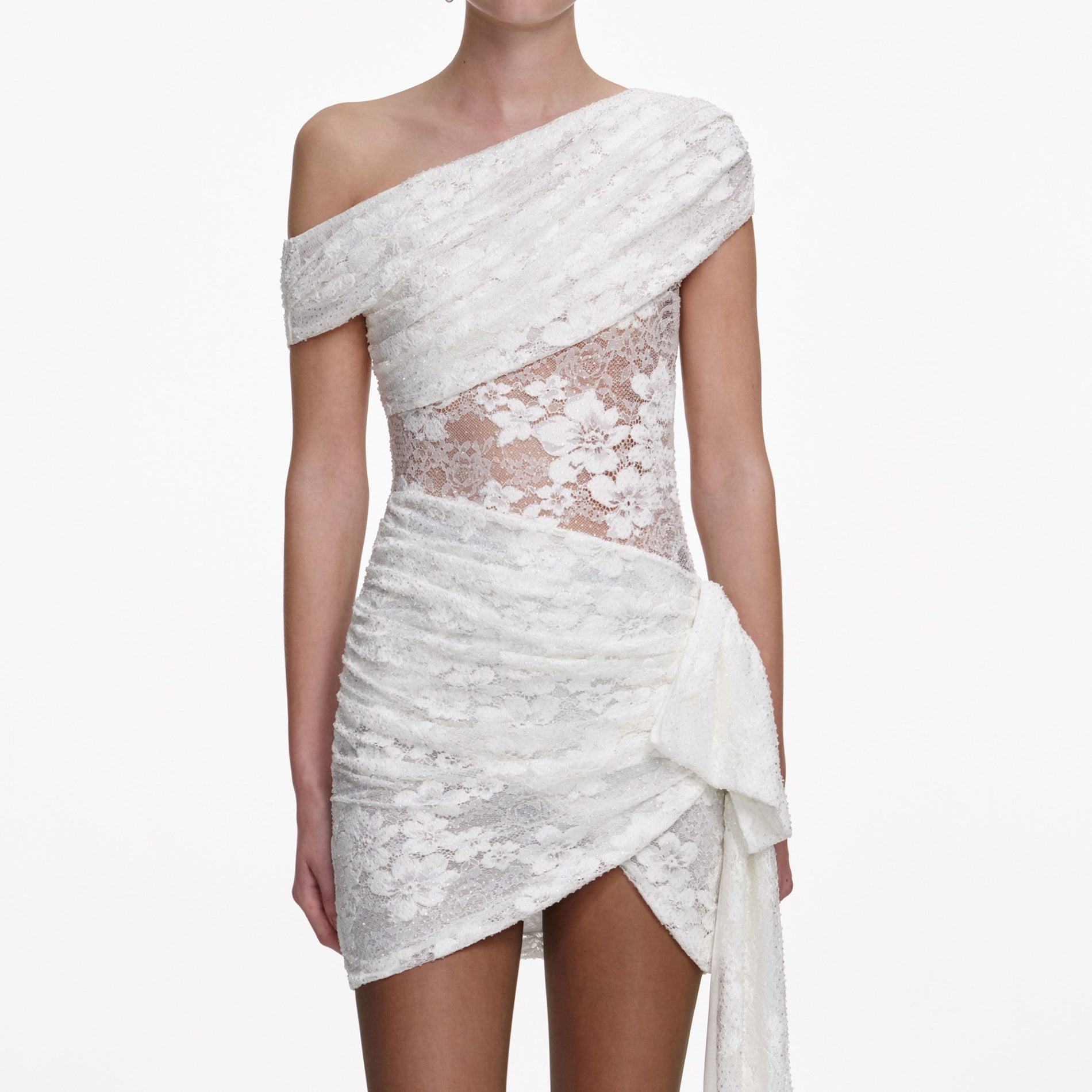 A close up of a woman wearing the White Rhinestone Lace Tie Side Mini Dress