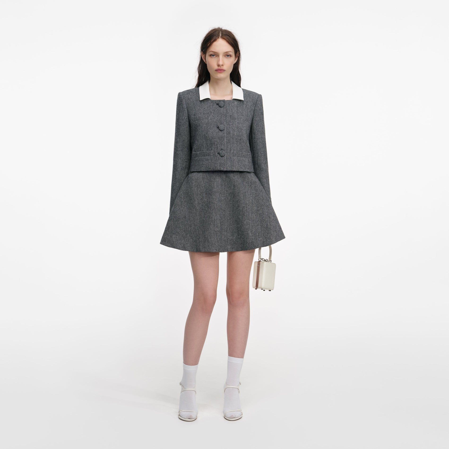 A close up of a woman wearing the Grey Herringbone Scarf Detail Jacket