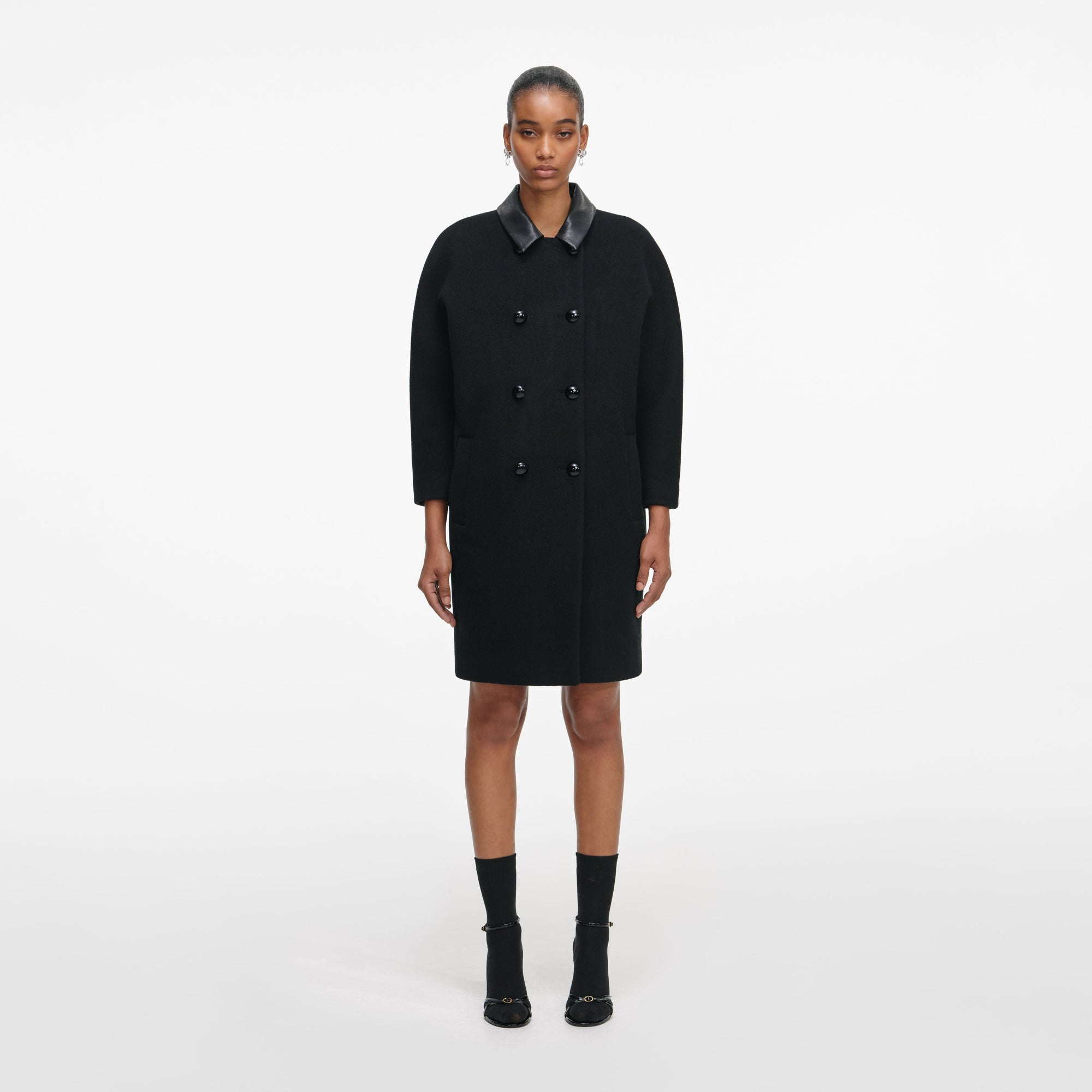 Front view of a woman wearing the Black Double Breasted Coat