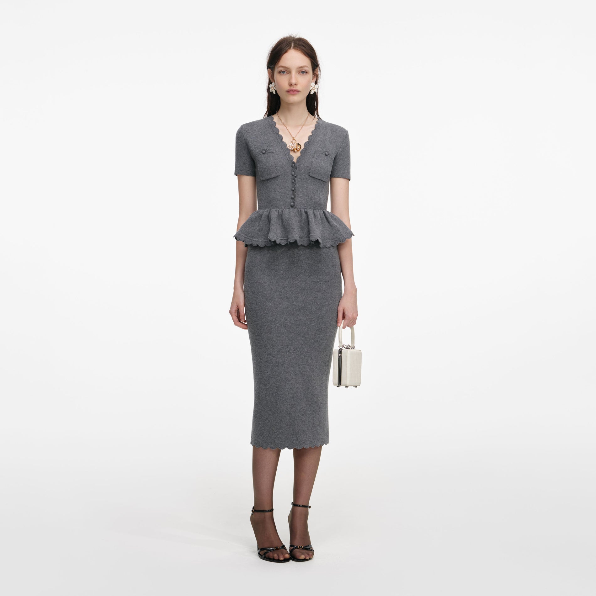 Front view of a woman wearing the Grey Peplum Knit Midi Dress