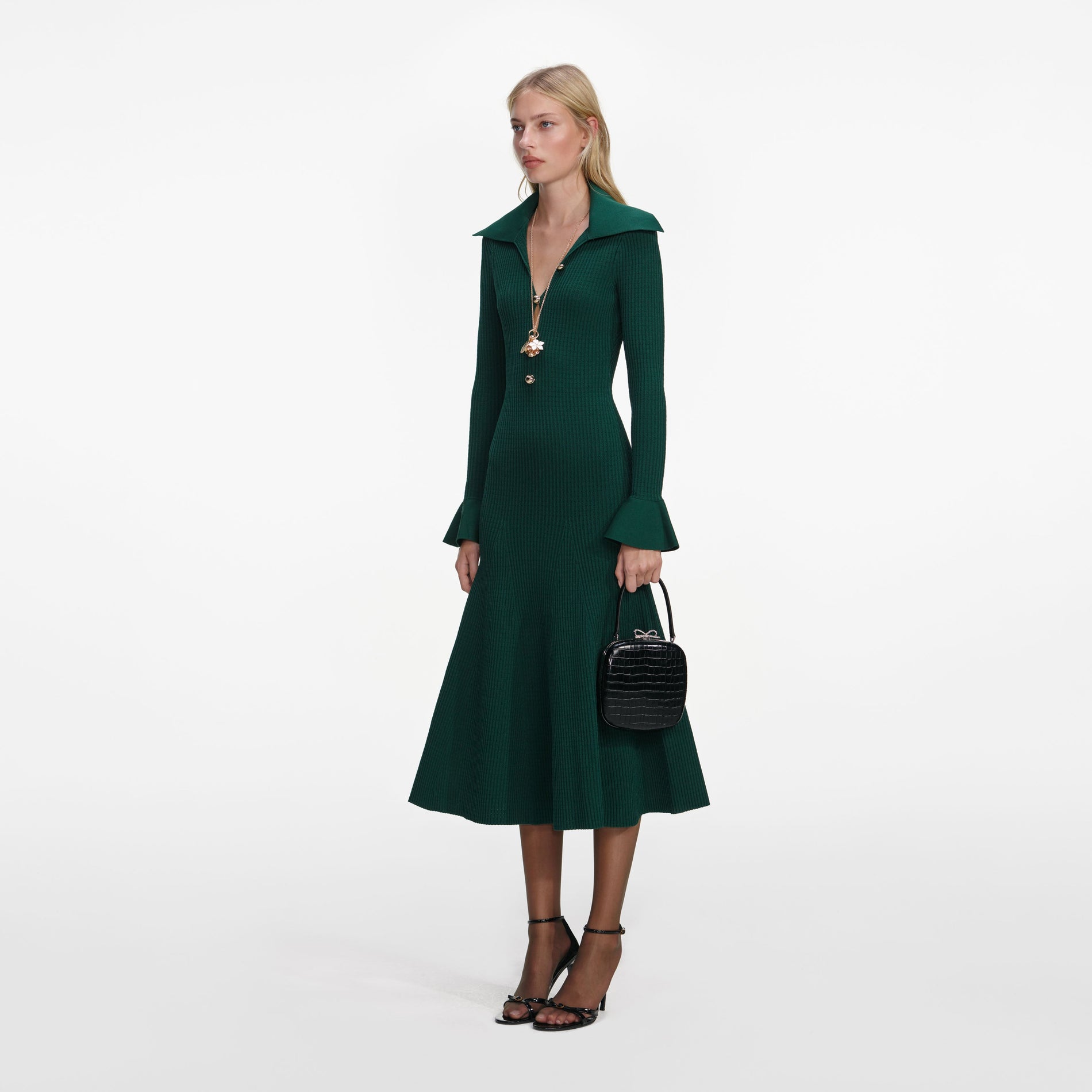 Side view of a woman wearing the Green Keyhole Knit Midi Dress