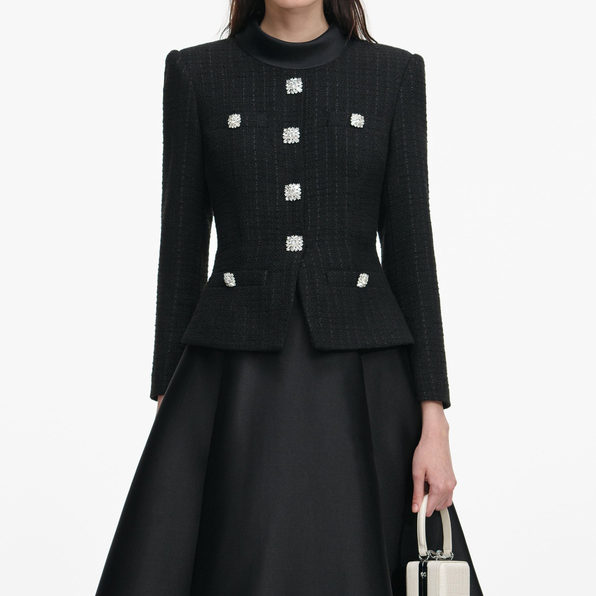 A close up of a woman wearing the Black Boucle Taffeta Midi Dress