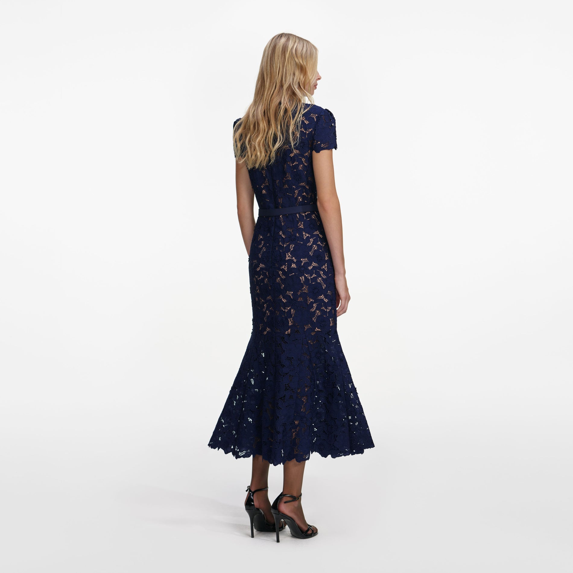 Back view of a woman wearing the Navy Guipure Lace Midi Dress
