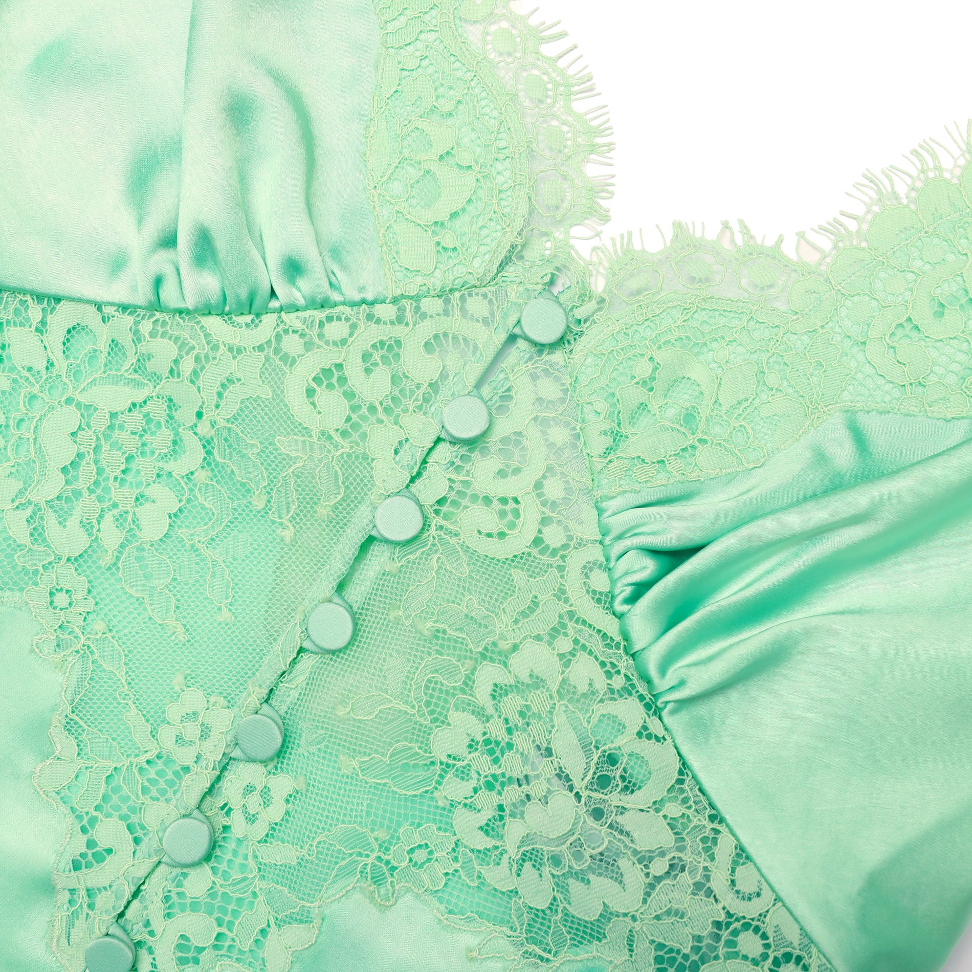 A close up of the fabric for the Green Satin Lace Top