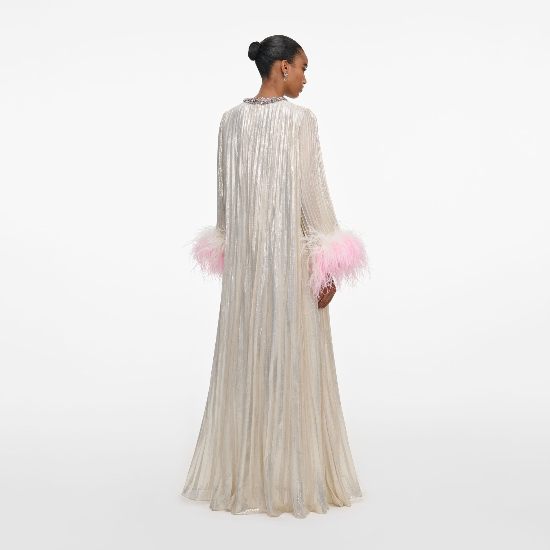 Back view of a woman wearing the Champagne Metallic Ombre Feather Maxi Dress