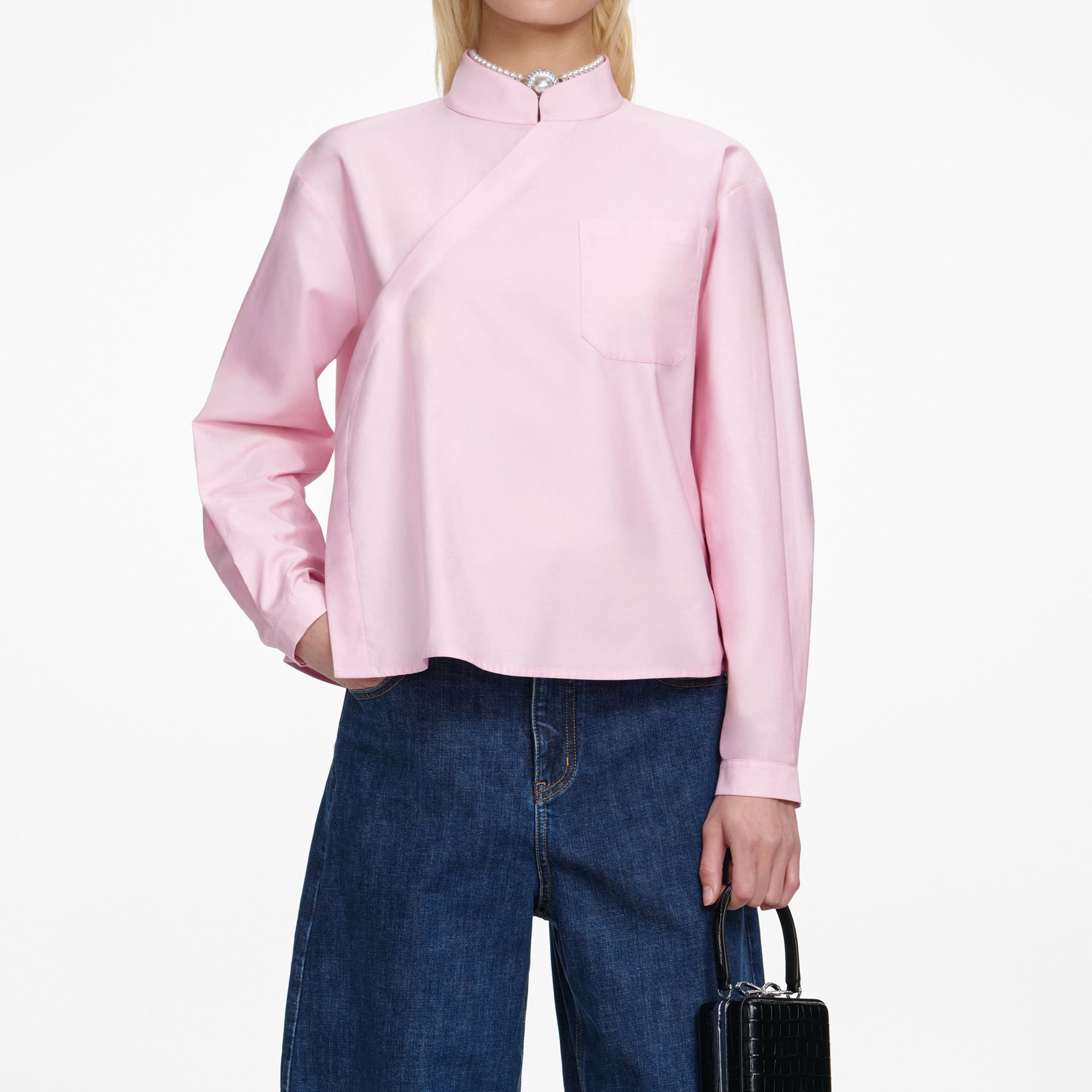 A close up of a woman wearing the Pink Cotton Asymmetric Shirt