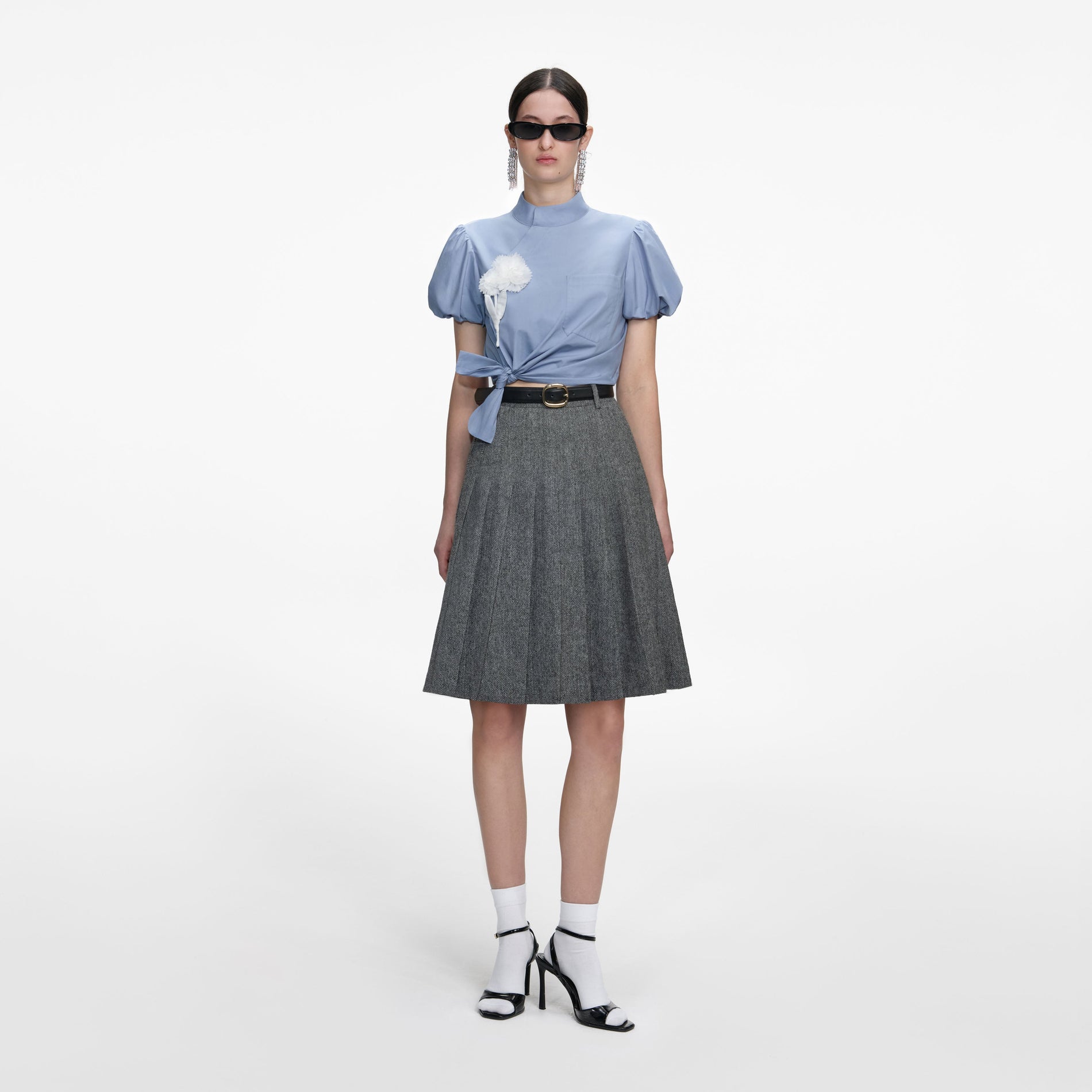 Front view of a woman wearing the Blue Cotton Tie Side Top