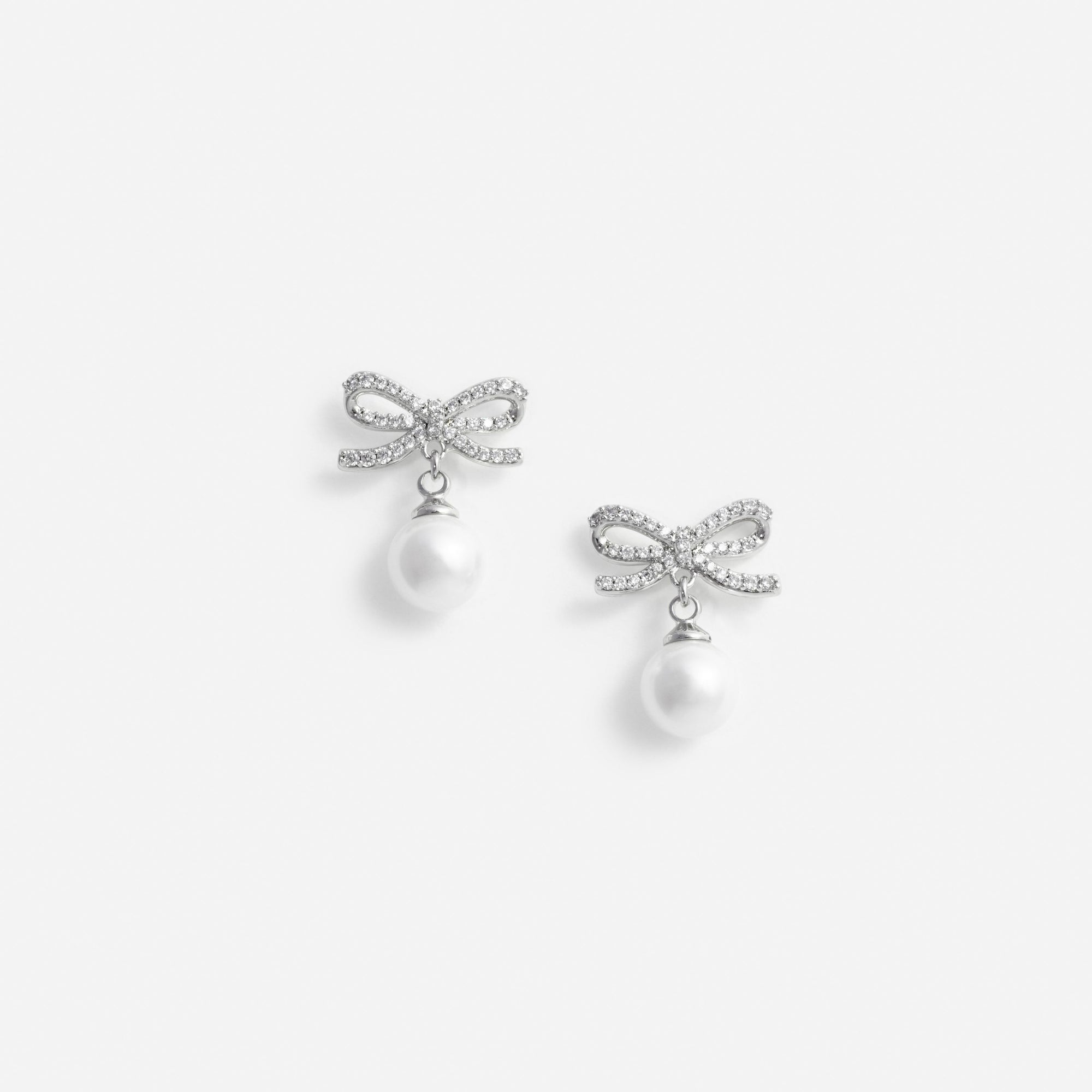 Pair of silver bow earrings with pearl drops
