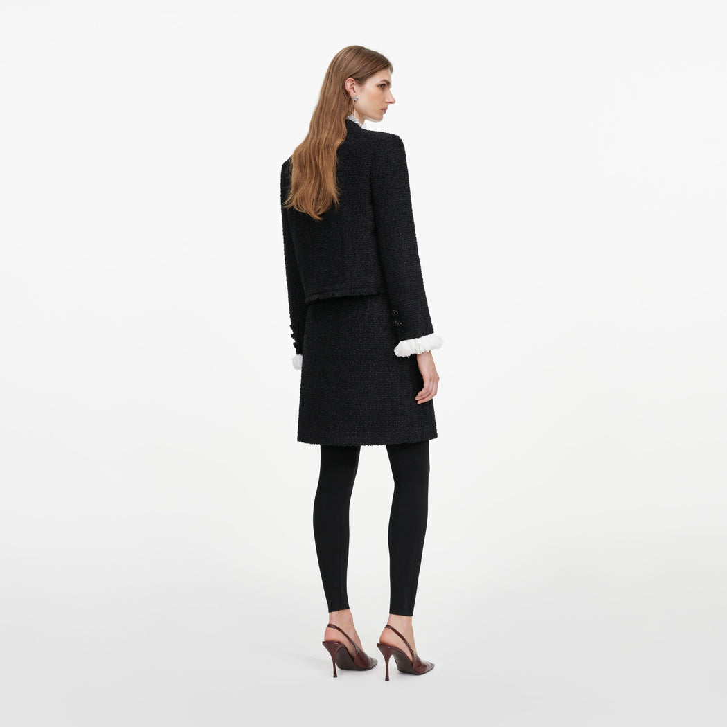 Back view of a woman wearing the Black Boucle Flower Jacket