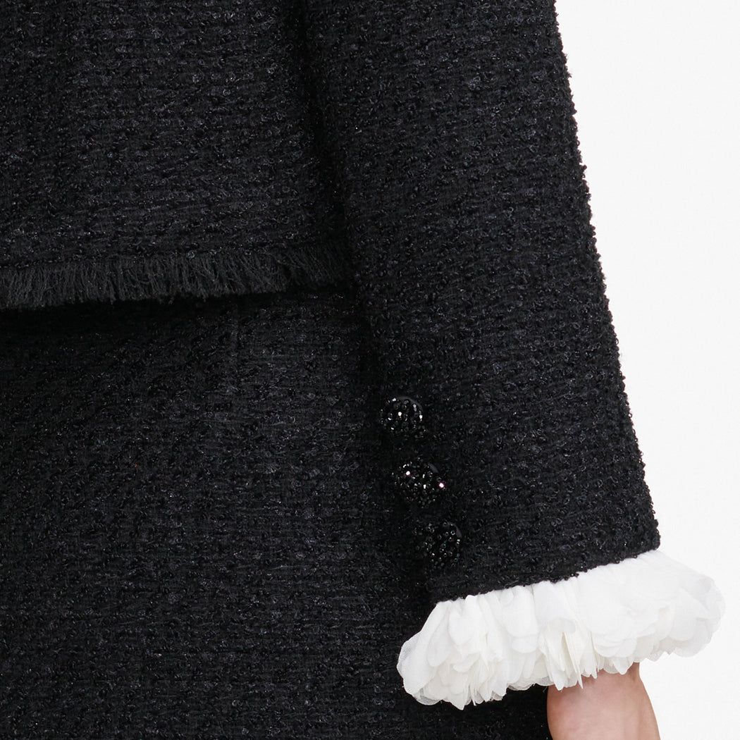 A close up of the fabric for the Black Boucle Flower Jacket