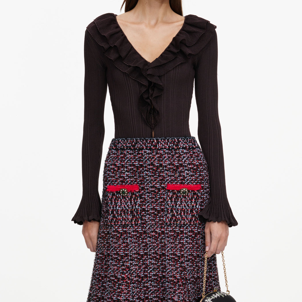 A close up of a woman wearing the Multi Textured Knit Midi Skirt