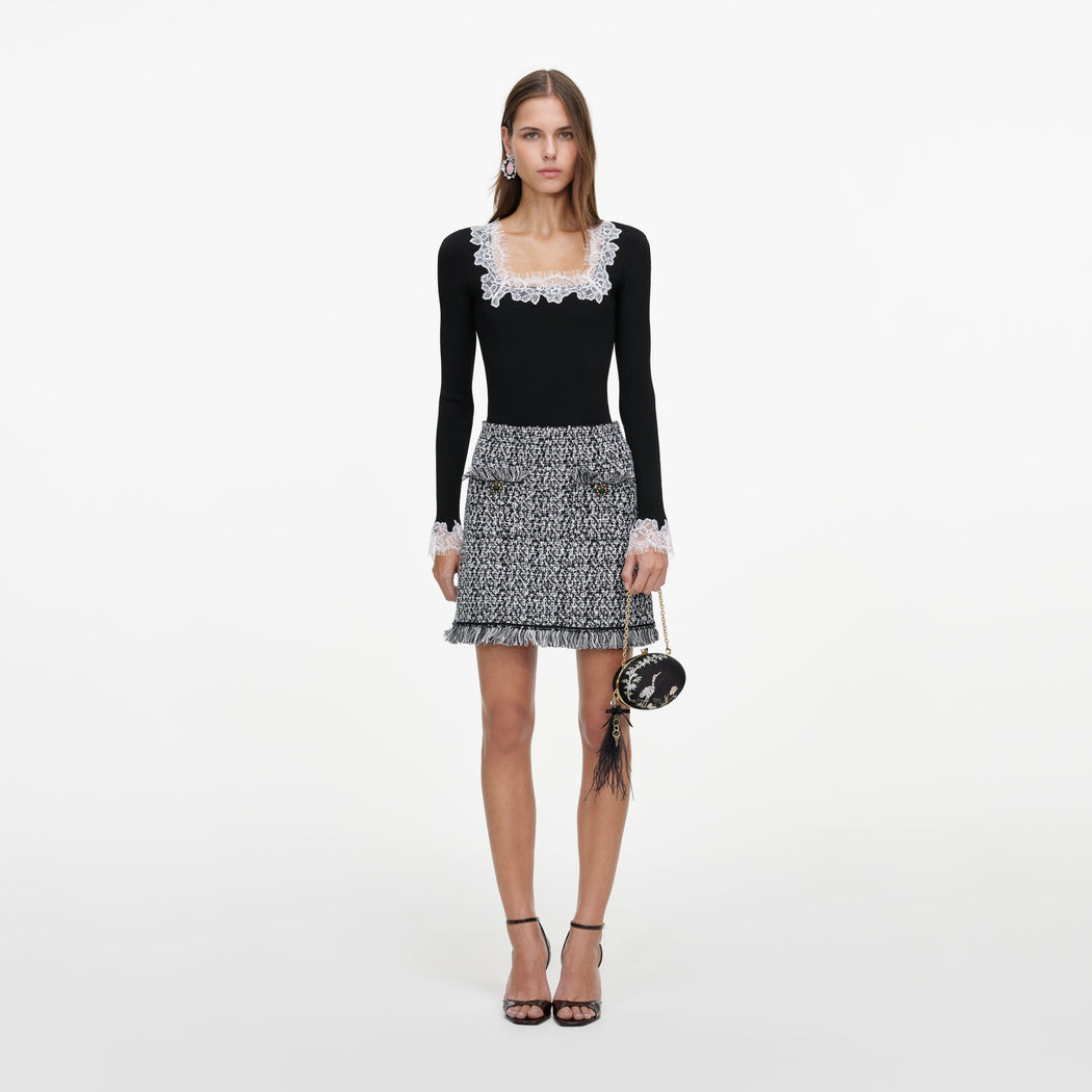 Front view of a woman wearing the Black And White Textured Knit Mini Skirt