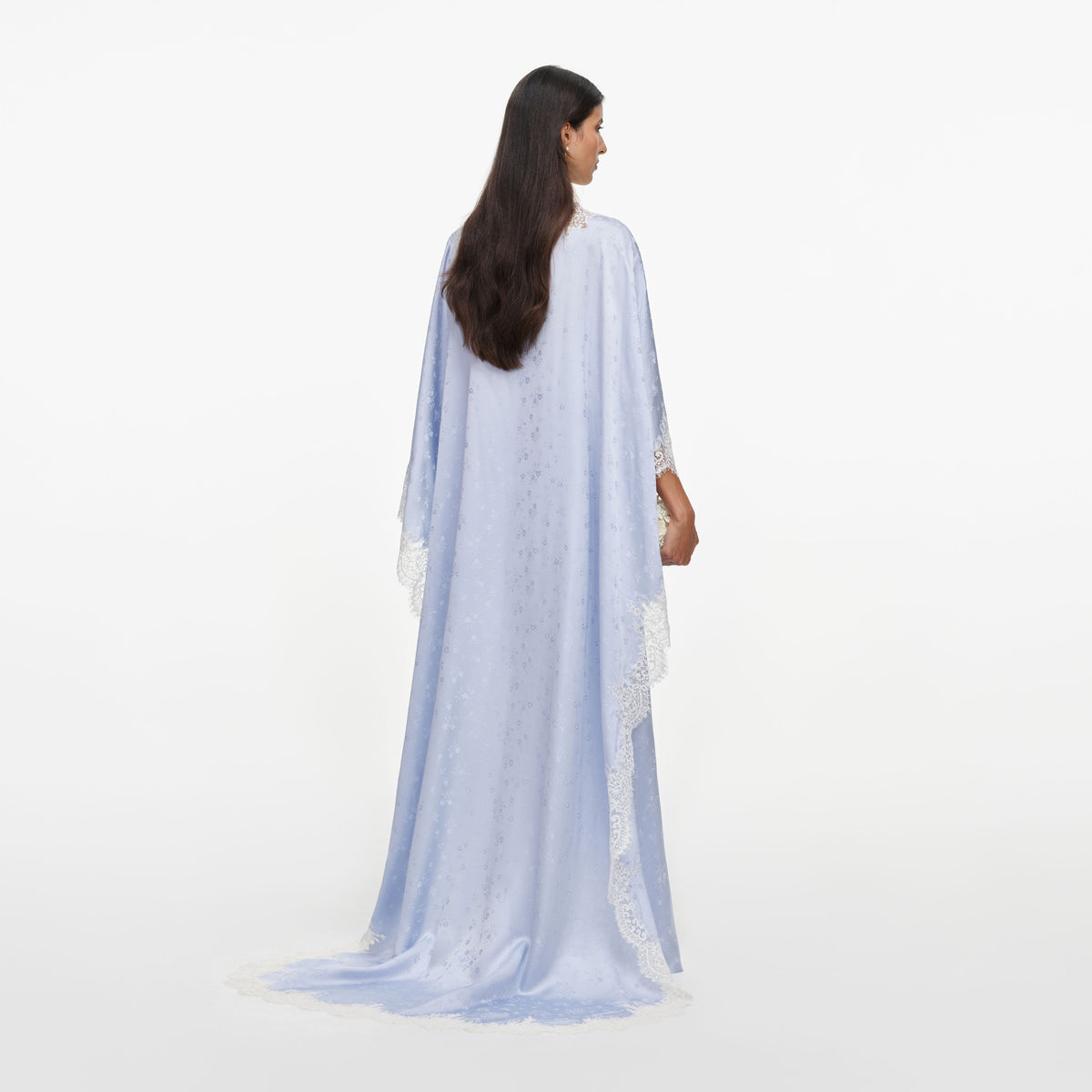 Back view of a woman wearing the Blue Satin Lace Cape Maxi Dress
