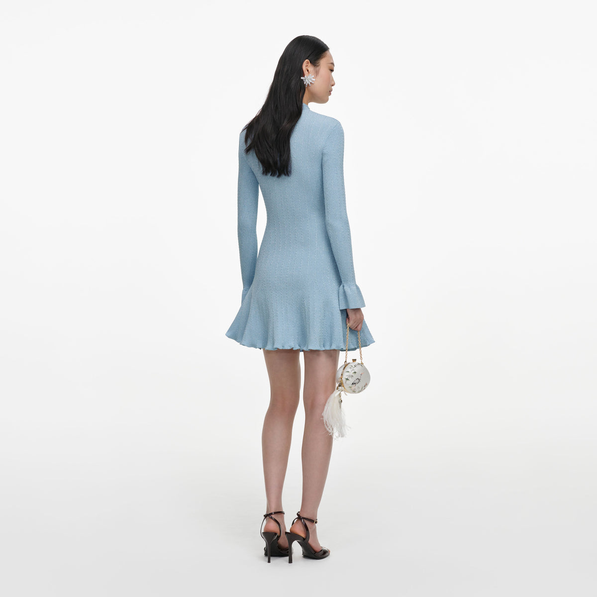 Back view of a woman wearing the Blue Metallic Knit Mini Dress