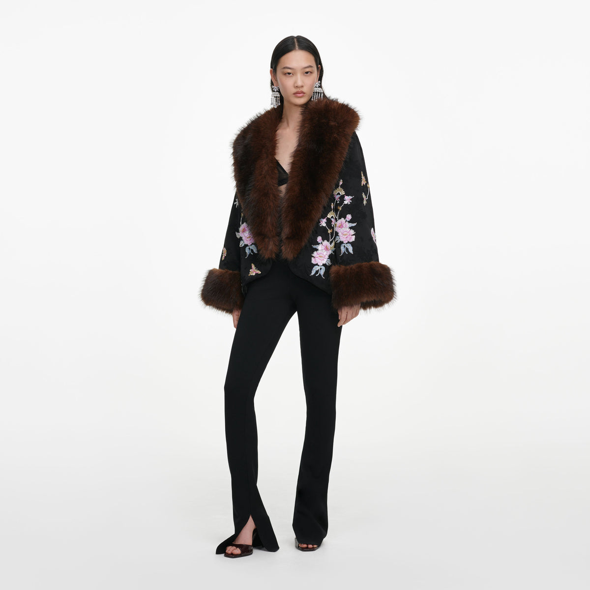 Side view of a woman wearing the Black Floral Jacquard Fur Collar Coat