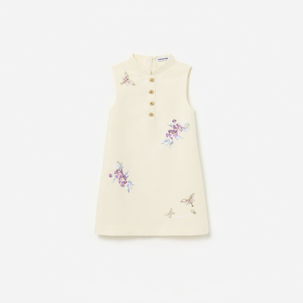 Front view of a girl wearing the Cream Floral Jacquard Sleeveless Dress