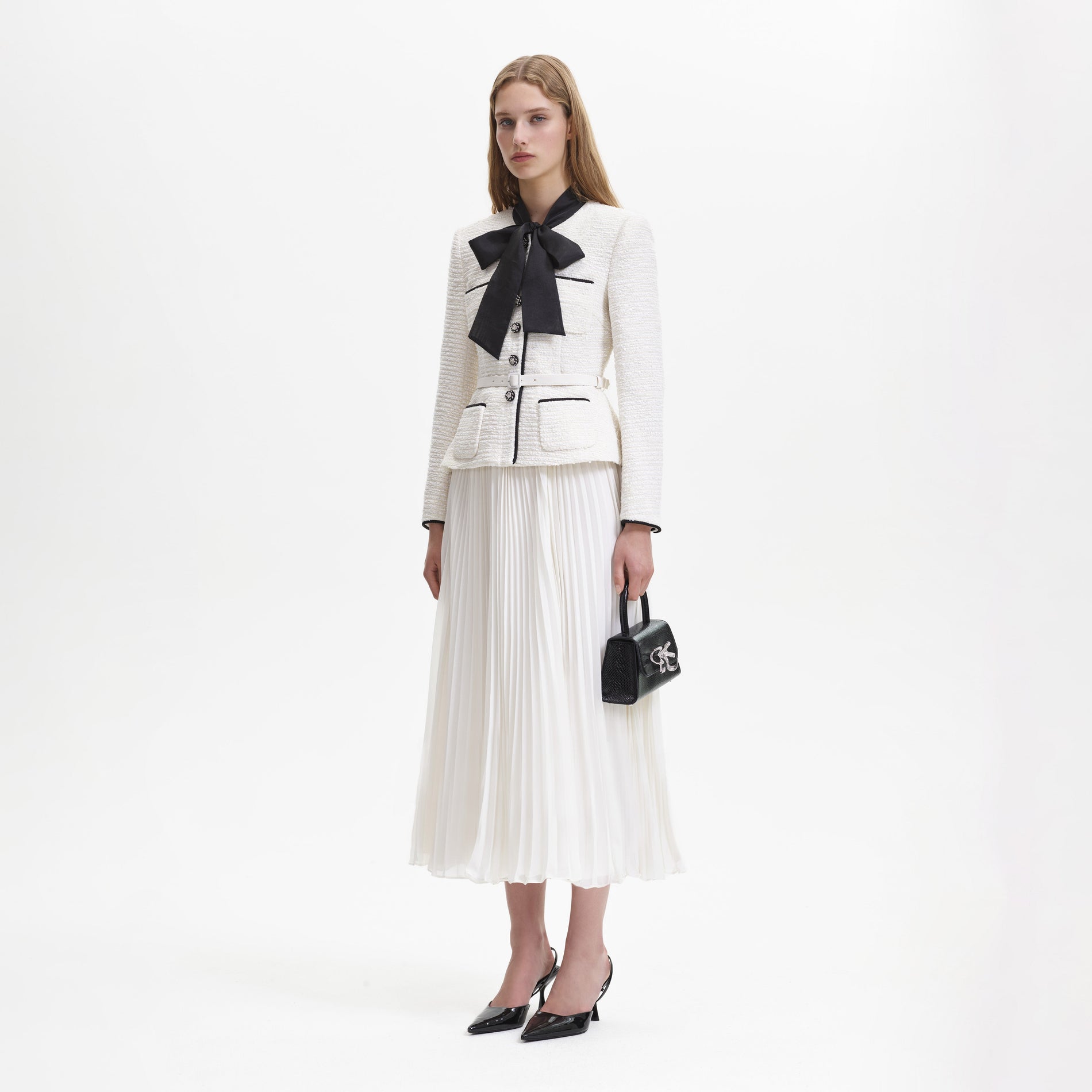 Side view of a woman wearing the Cream Boucle Pussy Bow Midi Dress