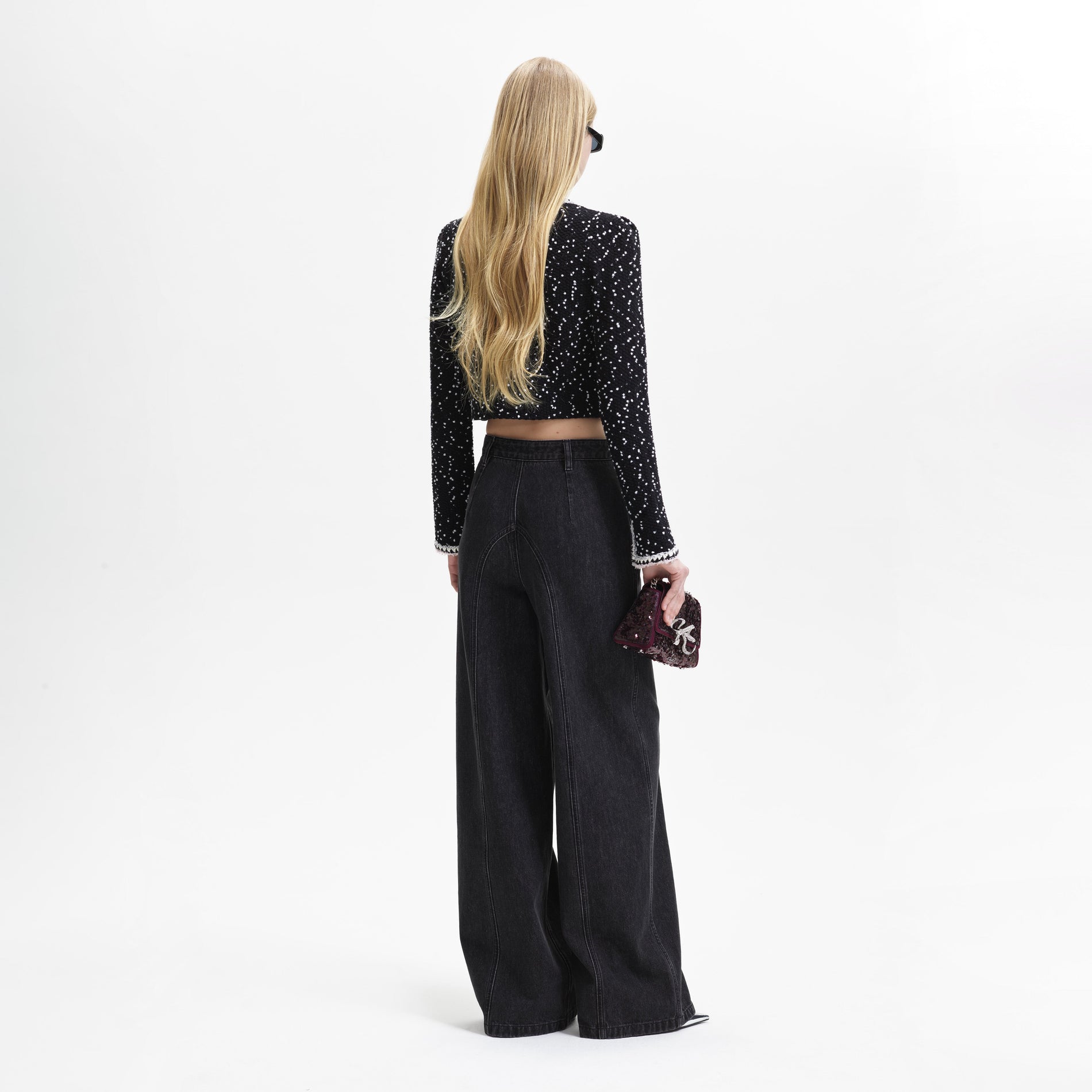 Back view of a woman wearing the Black & White Knit Cardigan