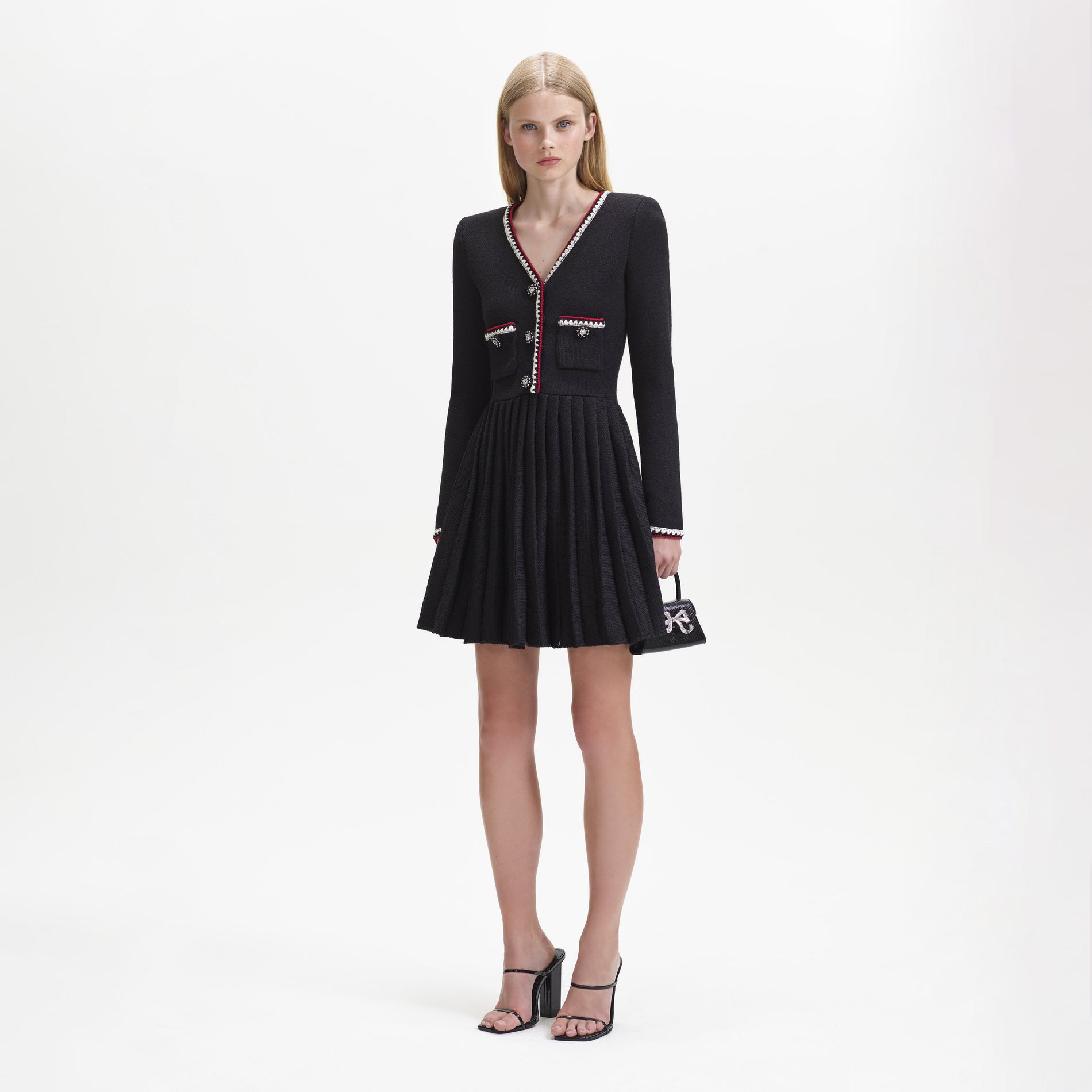 Side view of a woman wearing the Black Knit Mini Dress