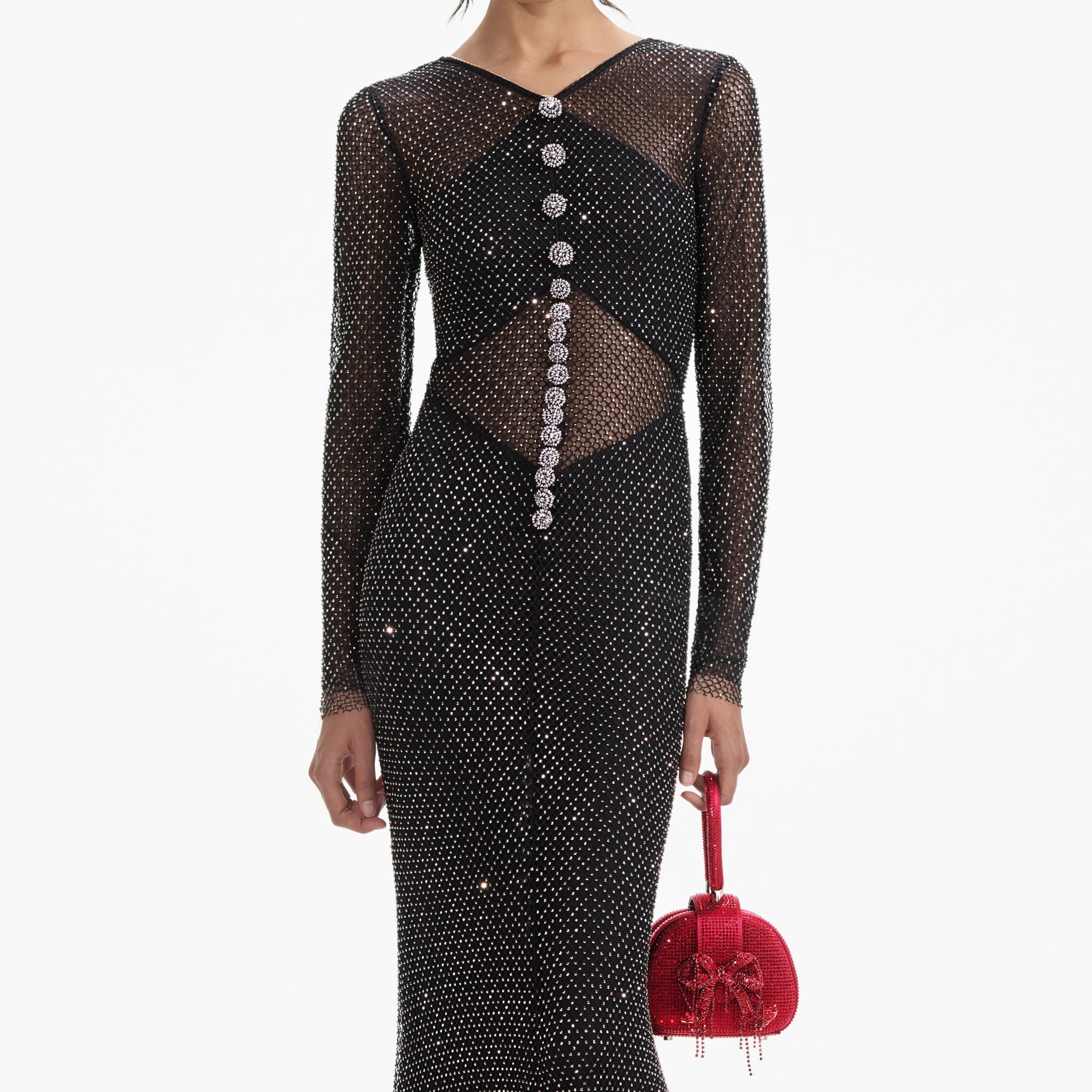 A close up of a woman wearing the Black Rhinestone Fishnet Crossover Maxi Dress