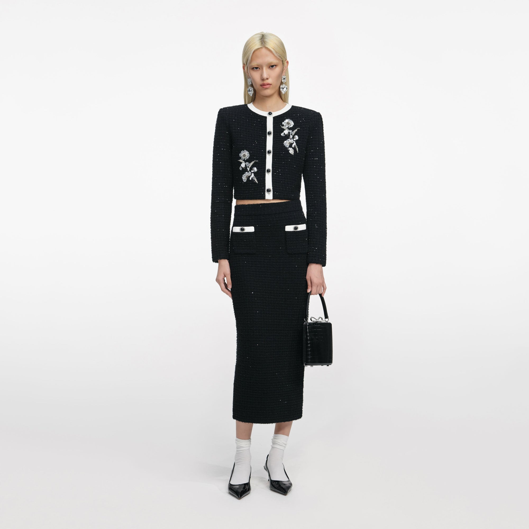 Front view of a woman wearing the Black Textured Knit Midi Skirt