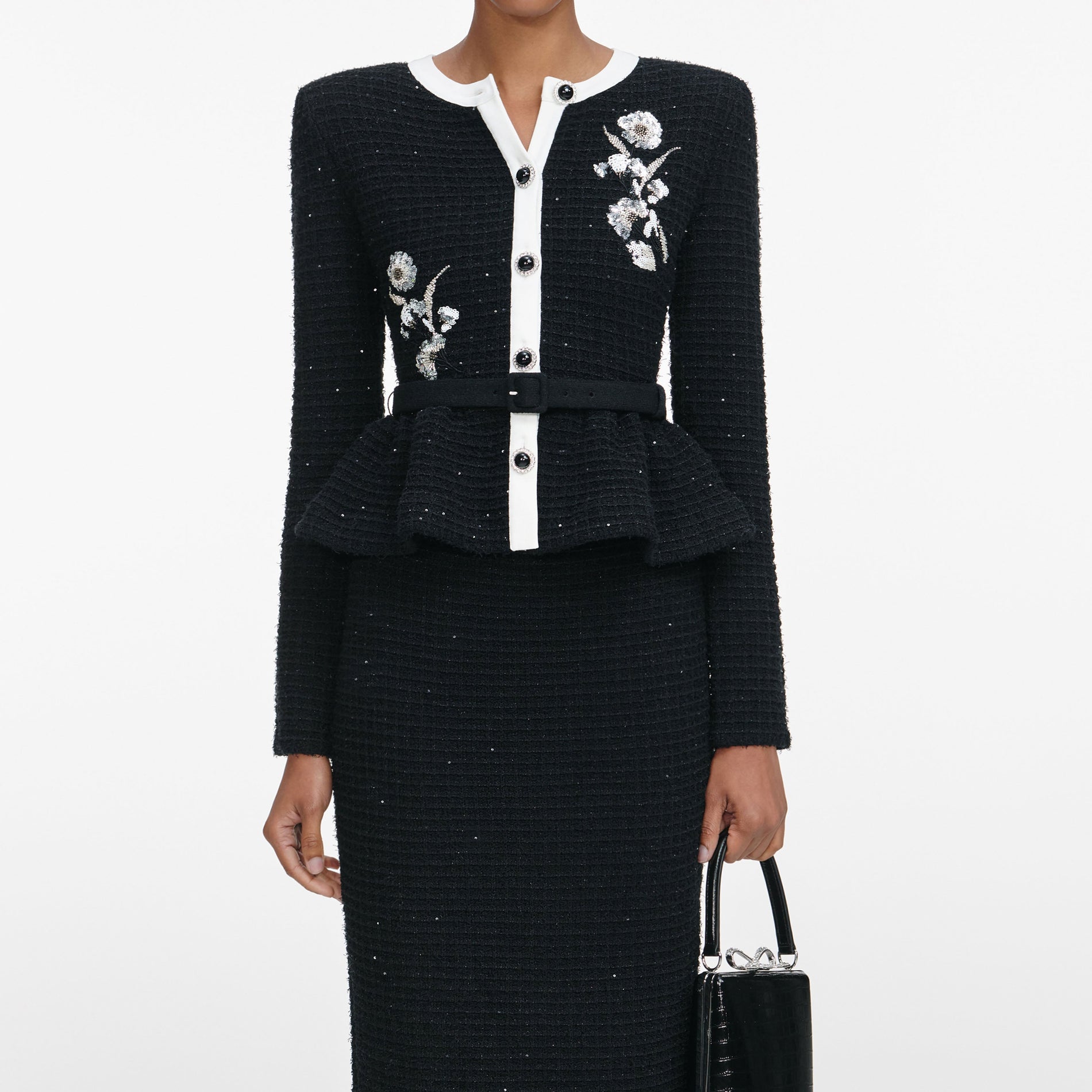 A close up of a woman wearing the Black Floral Textured Knit Midi Dress