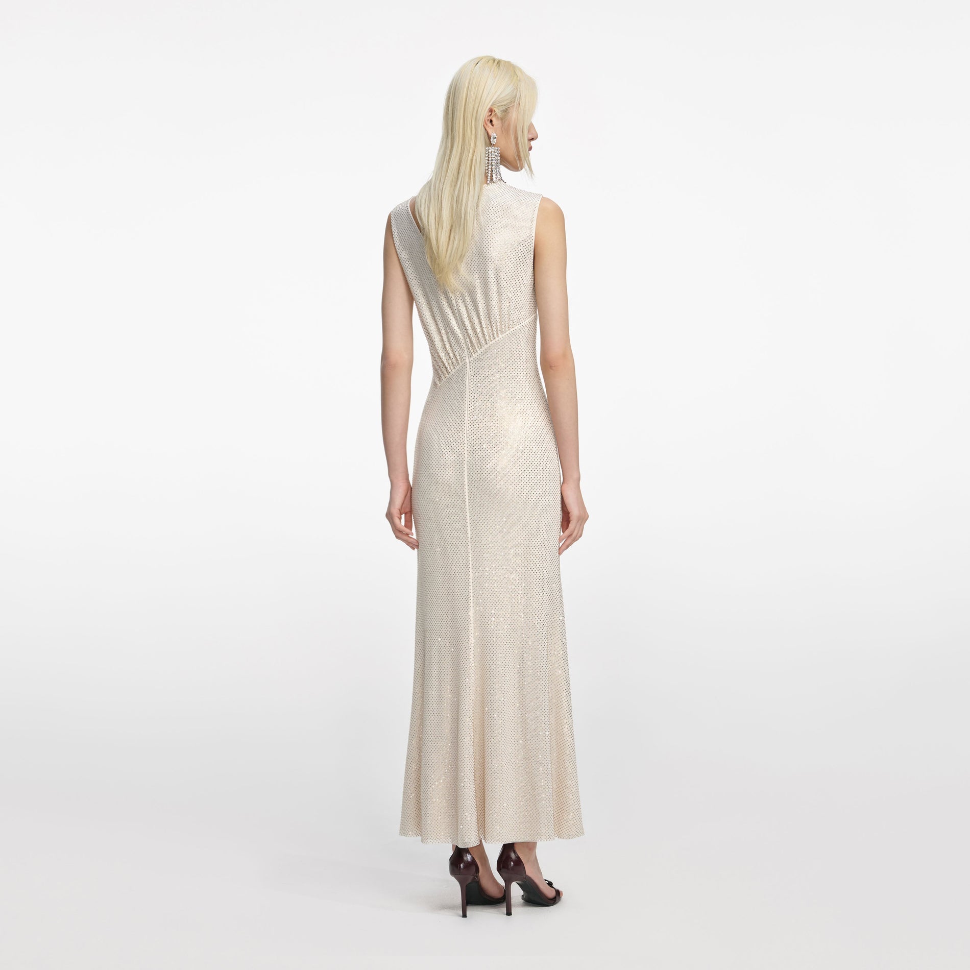 Back view of a woman wearing the Champagne Rhinestone Cut Out Midi Dress