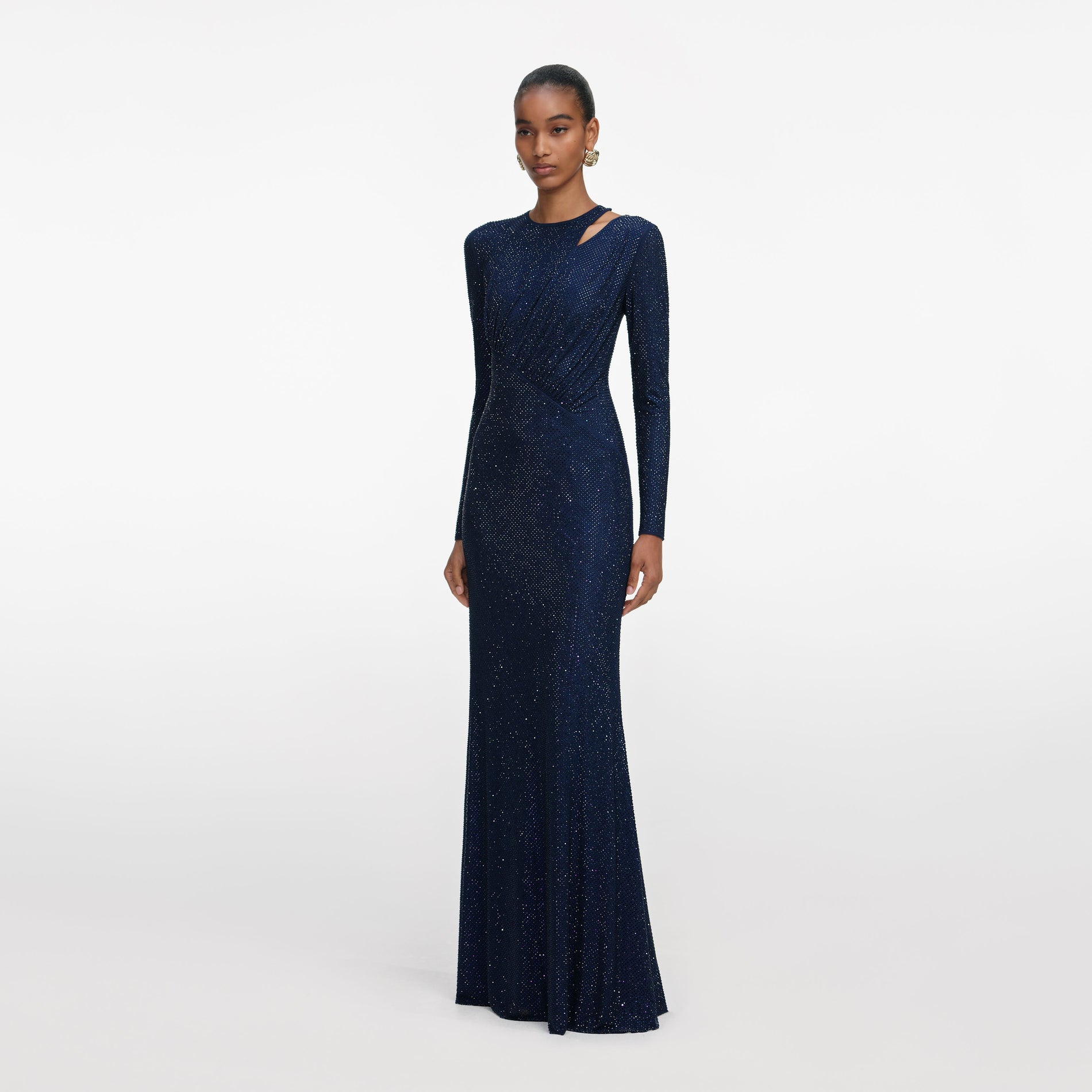 Side view of a woman wearing the Navy Rhinestone Mesh Cut Out Maxi Dress