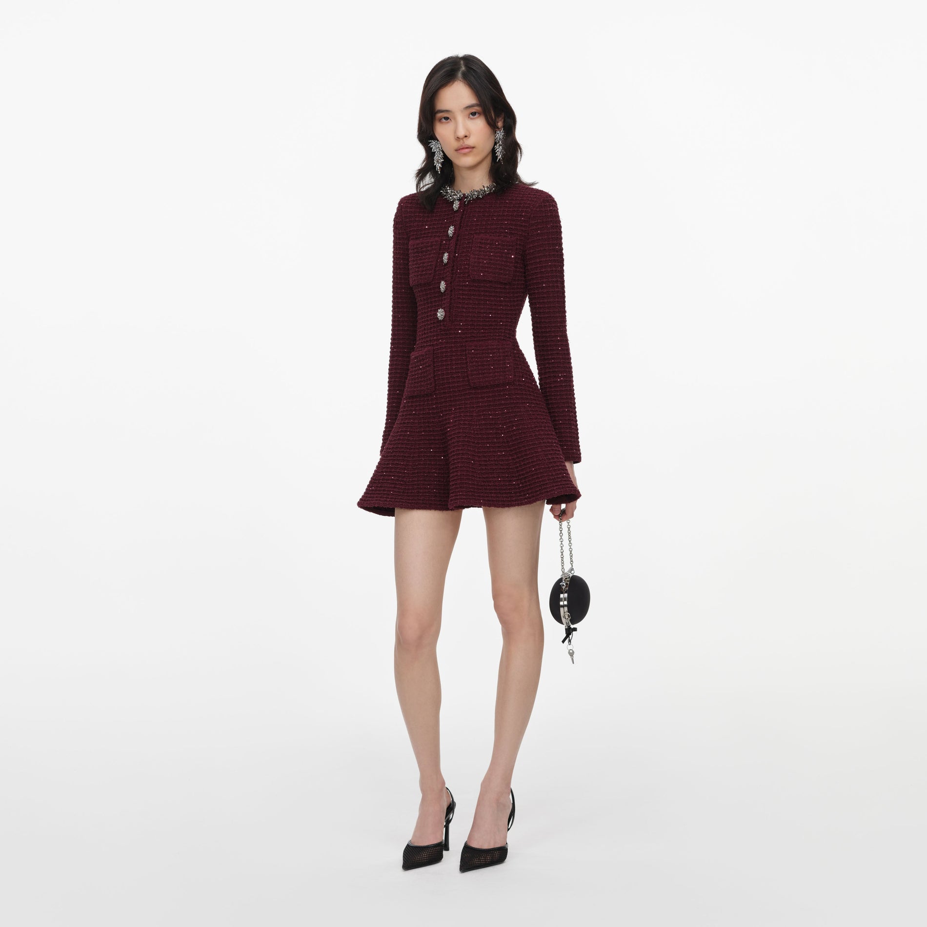Side view of a woman wearing the Burgundy Textured Knit Embellished Mini Dress