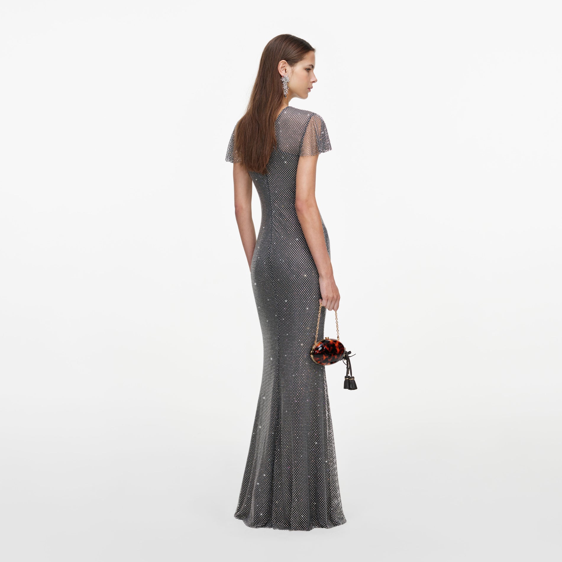 Back view of a woman wearing the Grey Rhinestone Fishnet Maxi Dress