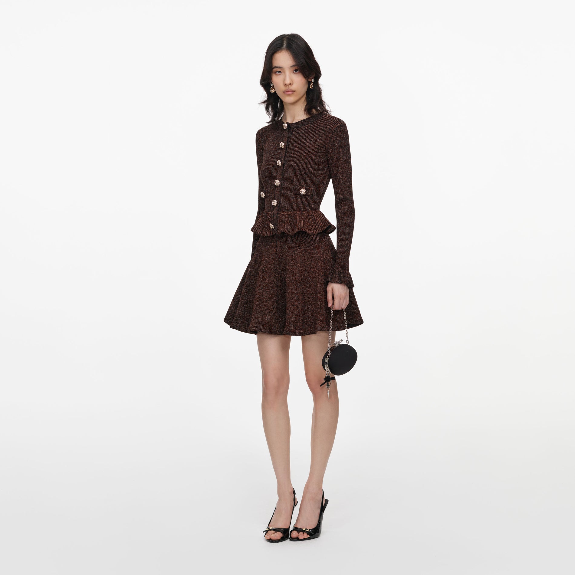 Side view of a woman wearing the Brown Lurex Peplum Knit Mini Dress