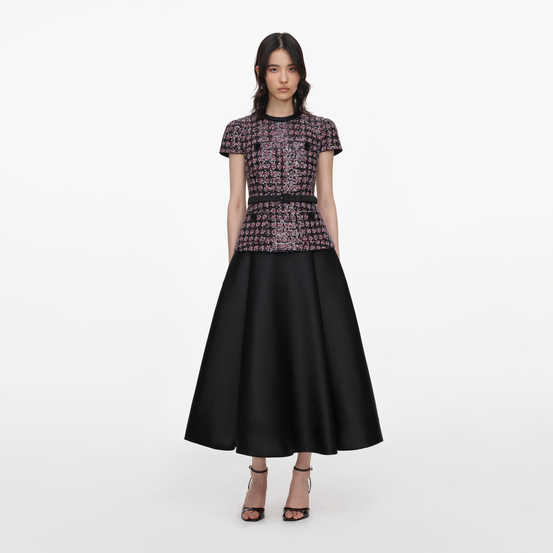 Front view of a woman wearing the Pink and Black Sequin Boucle Midi Dress