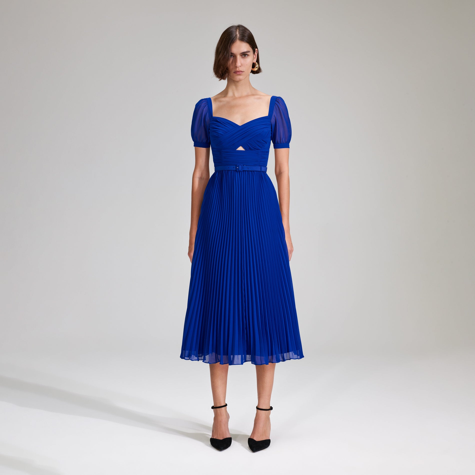 A woman wearing the Cobalt Chiffon Midi Dress