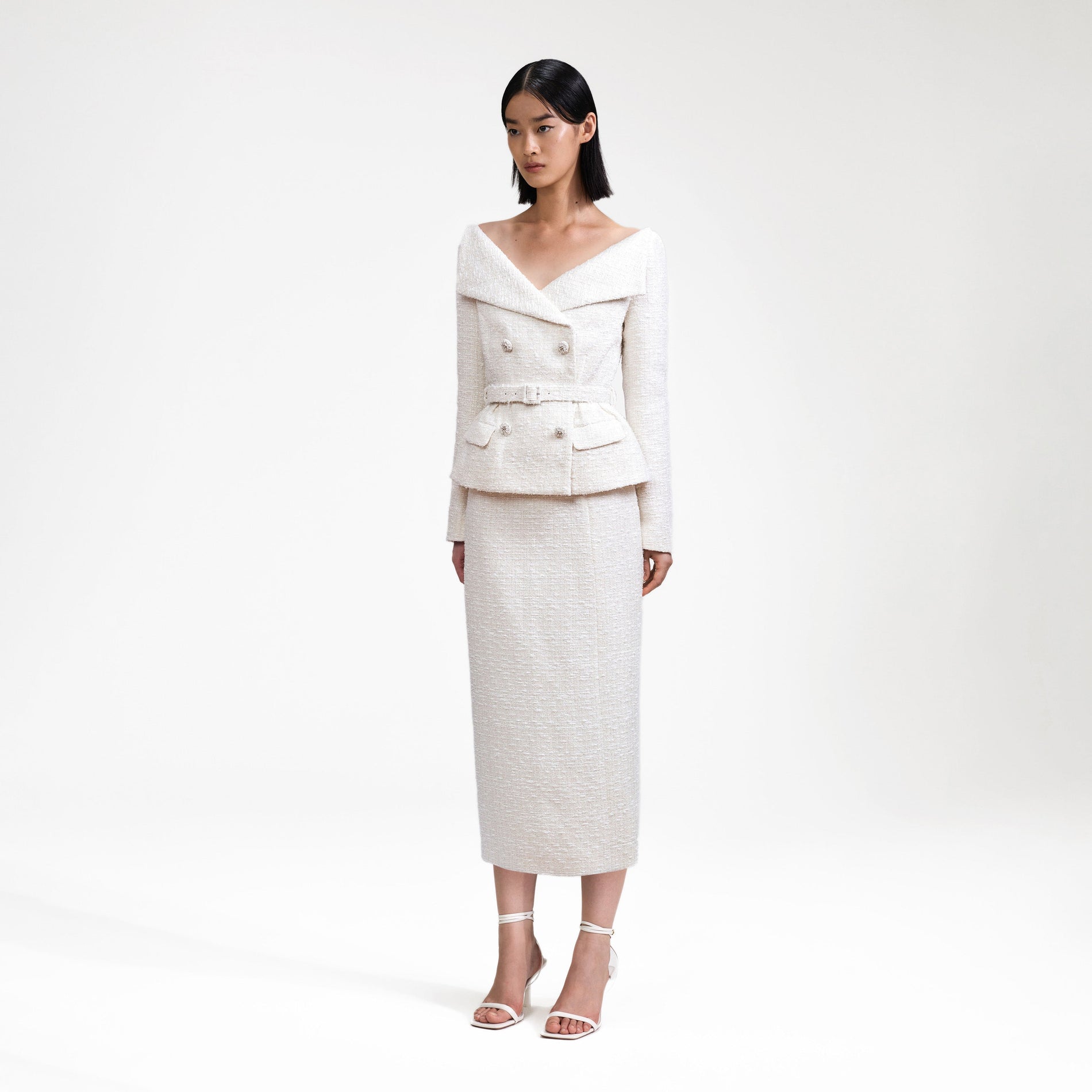 Side view of a woman wearing the Cream Off Shoulder Boucle Midi Dress