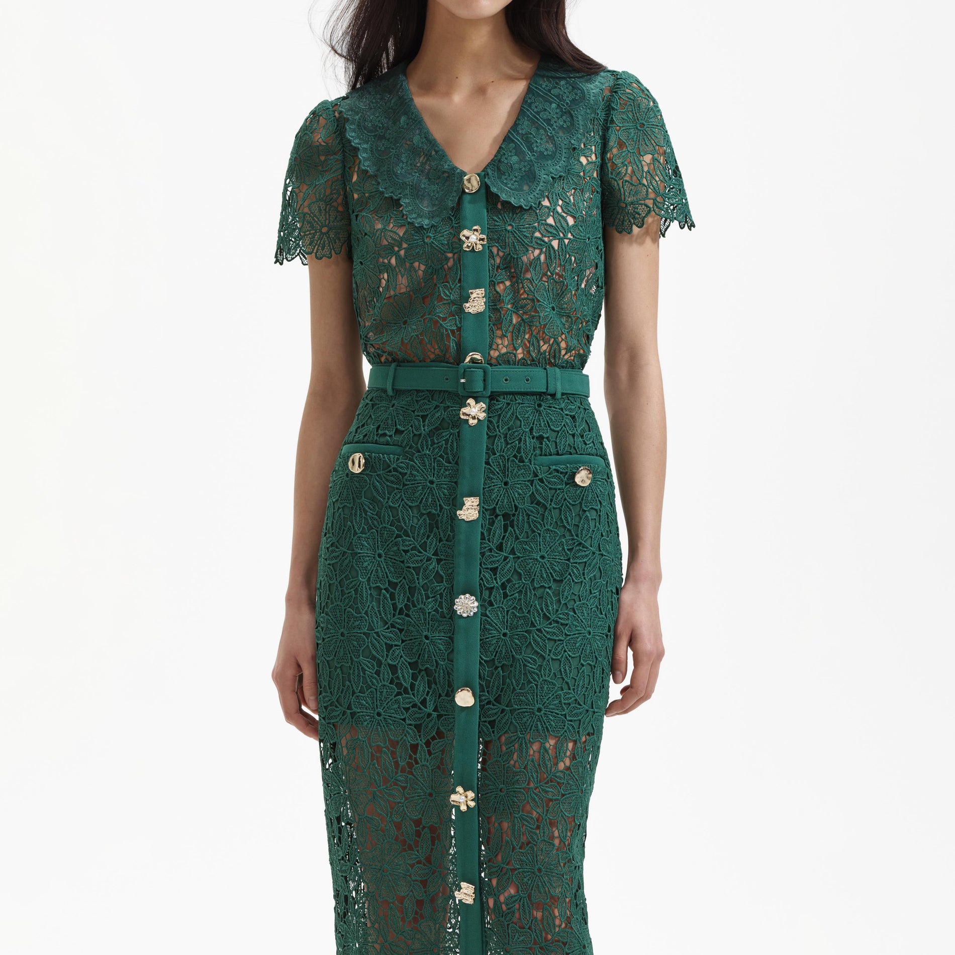 A close up of a woman wearing the Green Guipure Lace Top