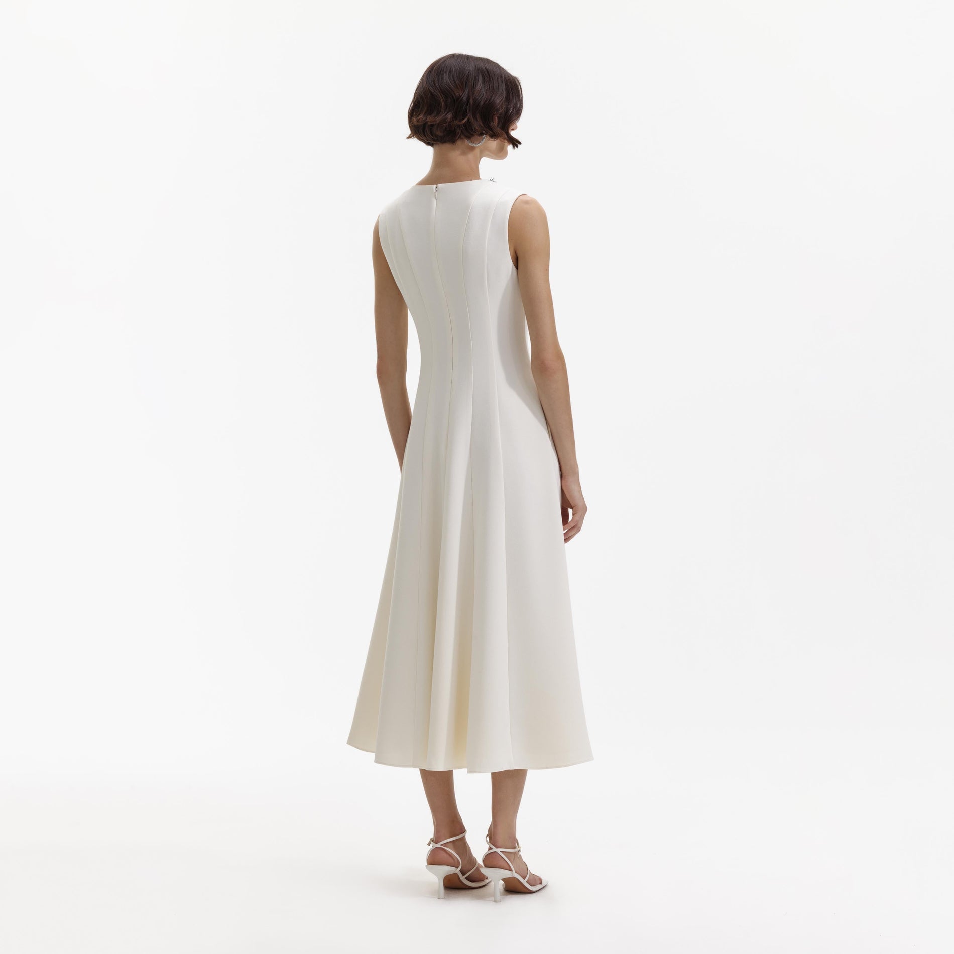 Back view of a woman wearing the Cream Crepe Embellished Midi Dress