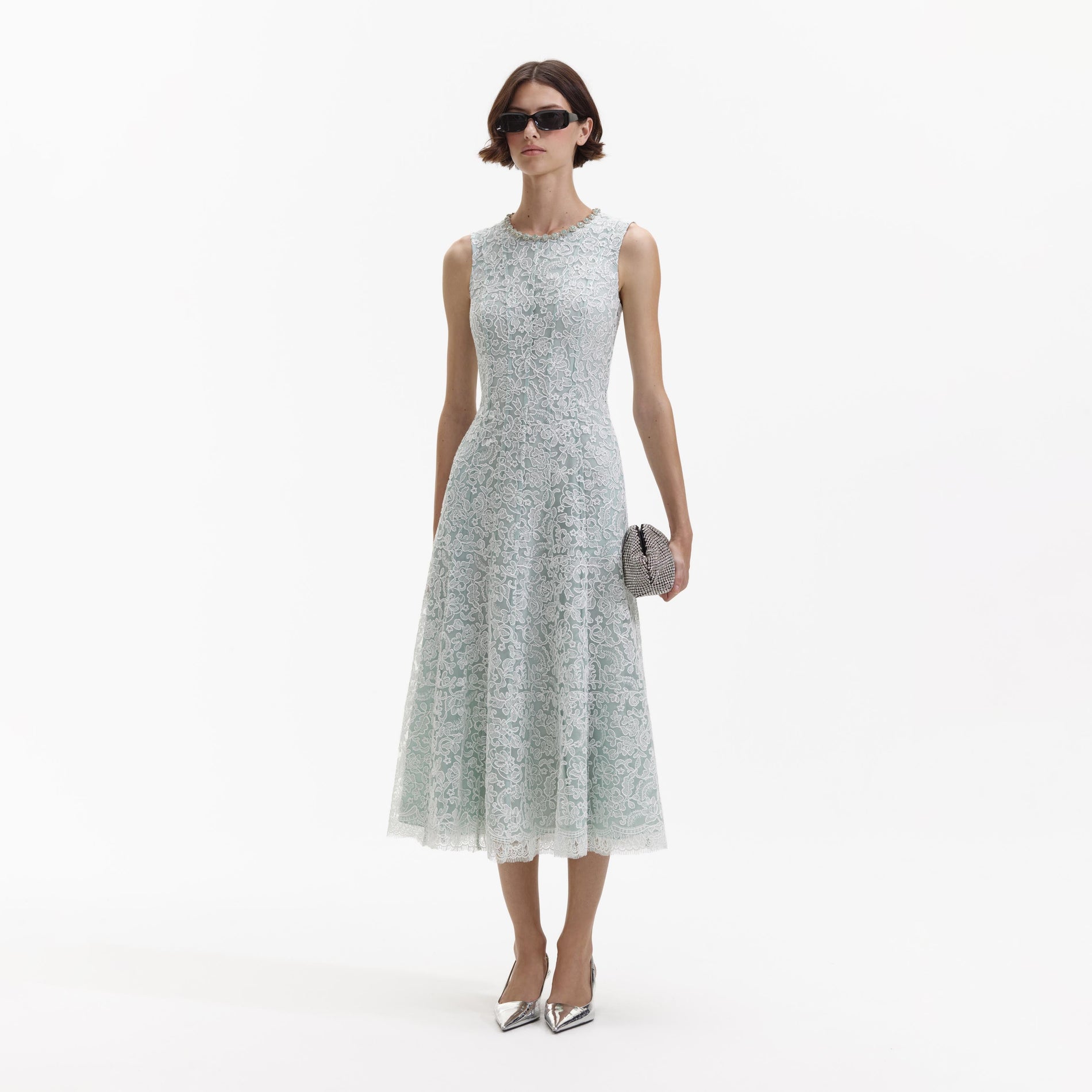Side view of a woman wearing the Green Cord Lace Round Neck Midi Dress