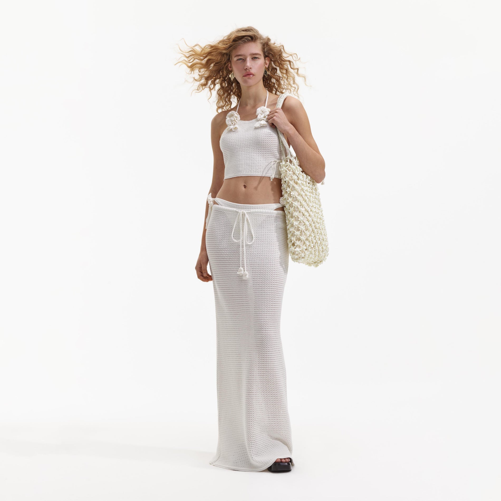 Front view of a woman wearing the White Crochet Maxi Skirt