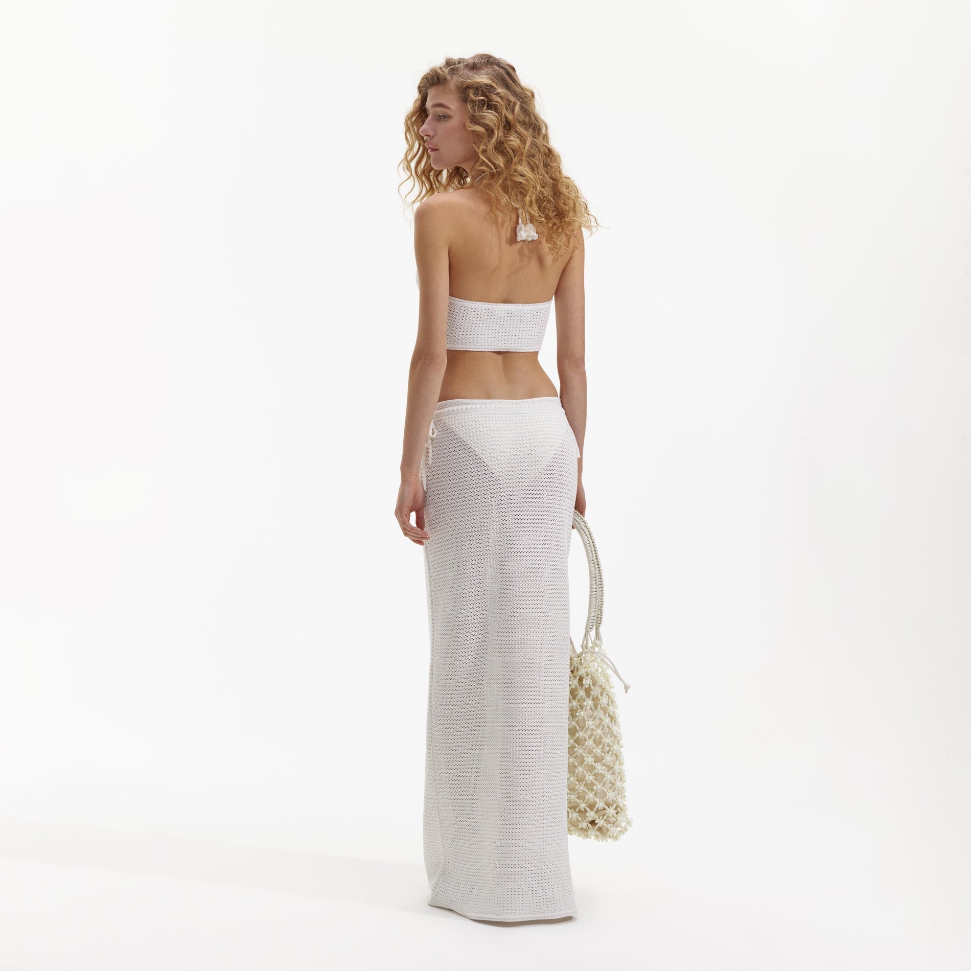 Back view of a woman wearing the White Crochet Maxi Skirt