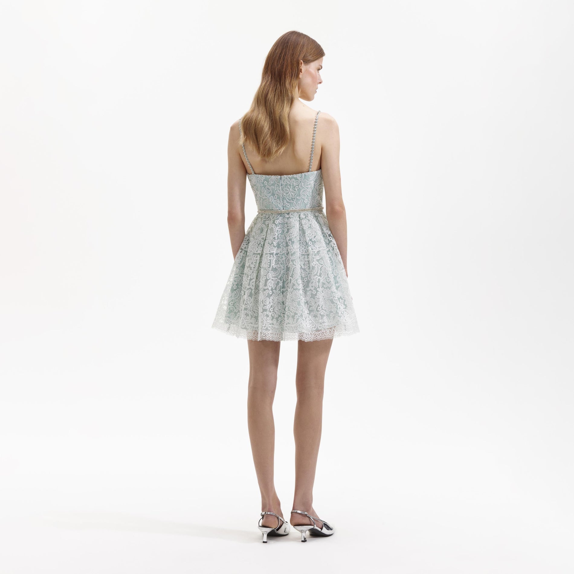 Back view of a woman wearing the Green Cord Lace Mini Dress