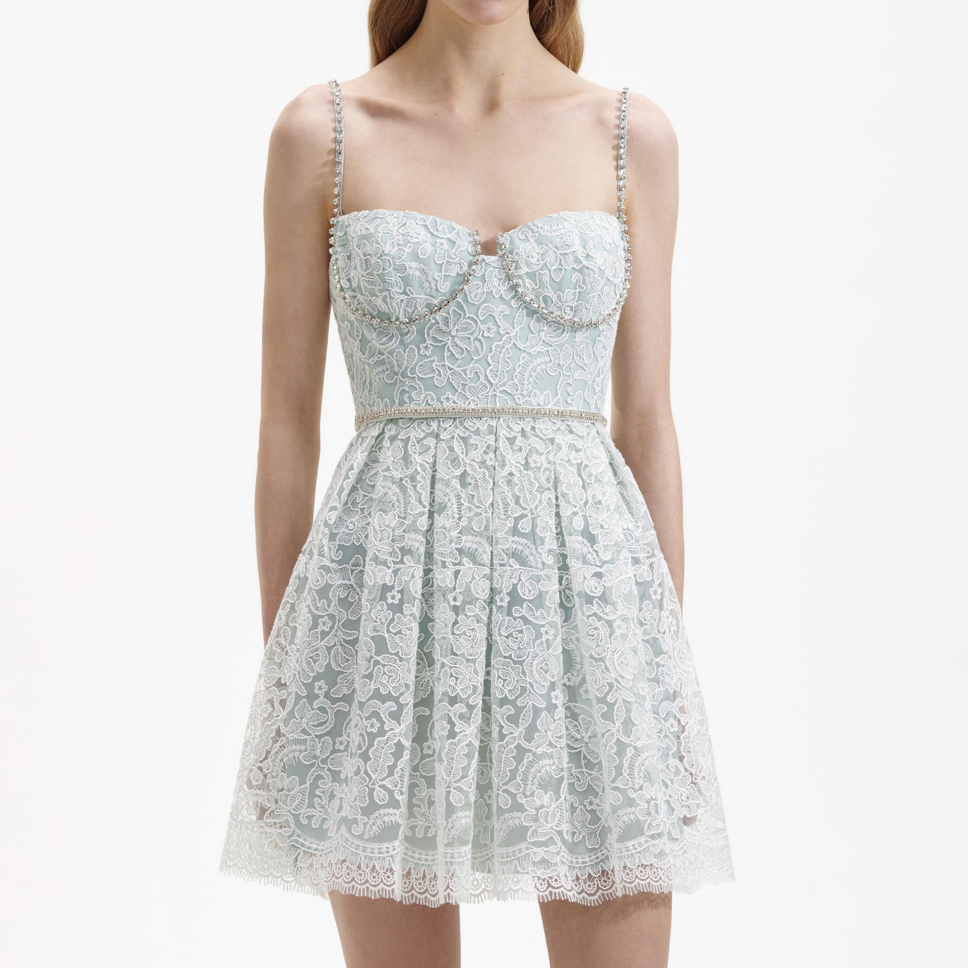 A close up of a woman wearing the Green Cord Lace Mini Dress