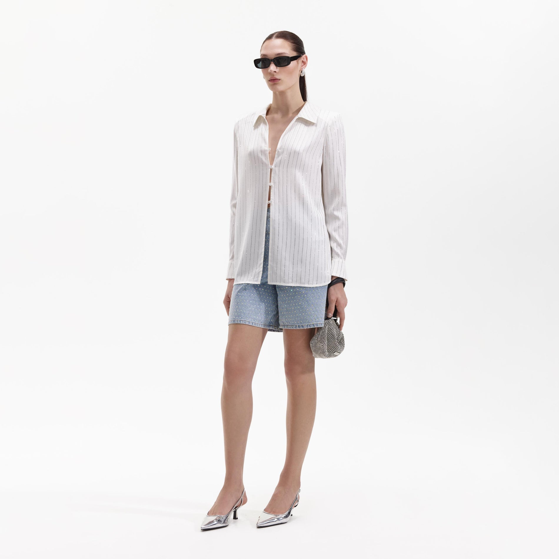 Side view of a woman wearing the White Rhinestone Stripe Shirt